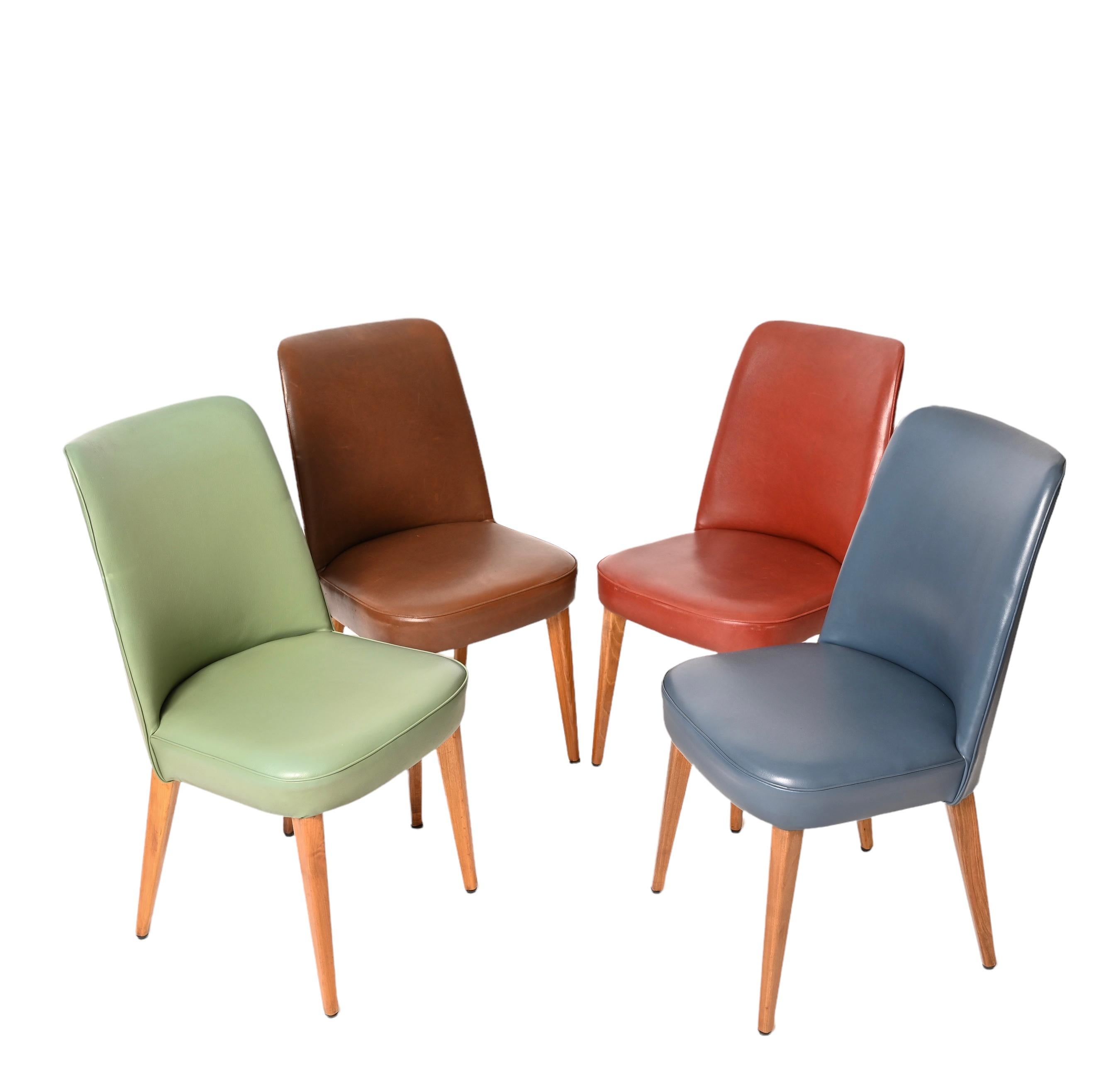 Incredible set of four chairs by Anonima Castelli Bologna Italy.
Padded and covered in the original leather of four different colors that make these chairs unique and really rare.
In fantastic condition, these four high-backed chairs will be a