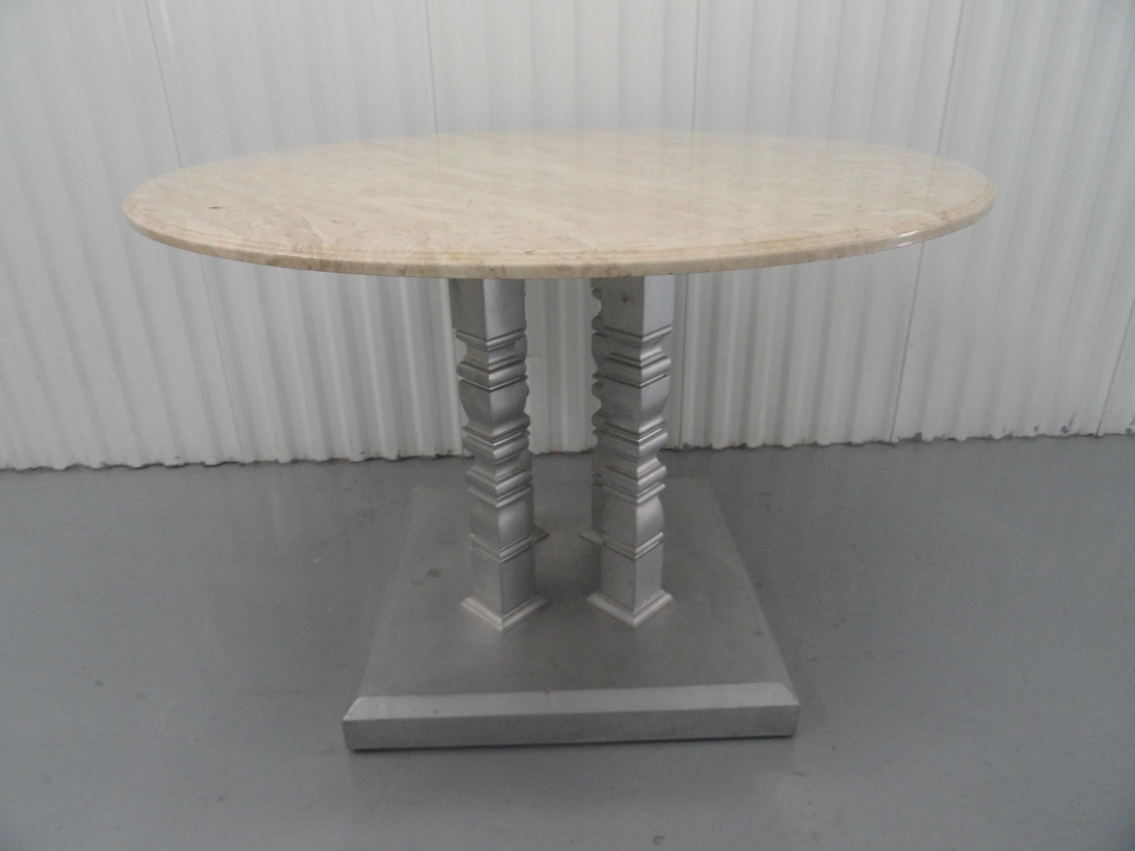 Custom designed table with four-column base, after a design by John Saladino.
Custom base with silver finish. Round marble top.
