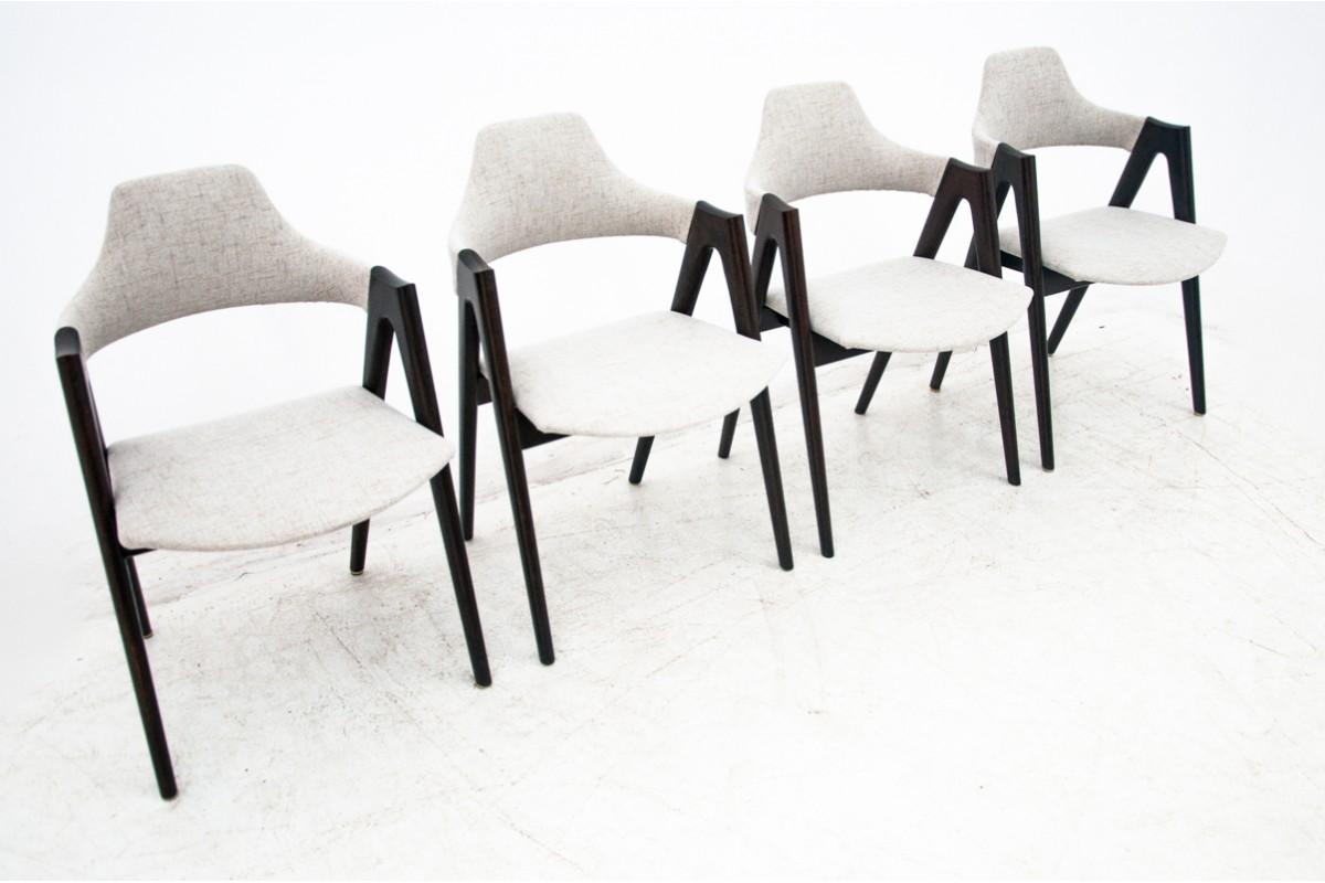 A set of four dining chairs designed by renowned Danish designer Kai Kristiansen was manufactured in Denmark in the 1960s. The chairs are after wood renovation. Upholstery after renovation, beige cotton high quality material. 
Measures: 53 cm