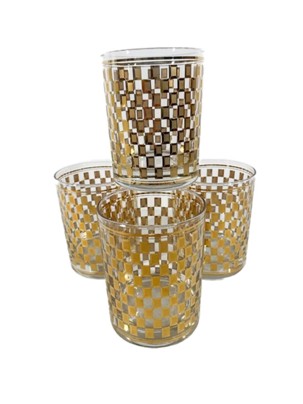 Four double rocks glasses by Culver, LTD with a checkerboard design made of vertical rectangles touching at the corners and having burnished edges framing satin finished centers.