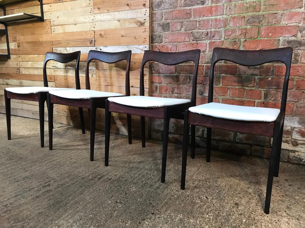 Stunning set of four exceptional chairs designed by Danish furniture designer Moller. Newly upholstered in a white leather, the chairs are in very good vintage condition.

Measures: Seat height 46cm, height 78cm, depth 55cm, width 46cm.