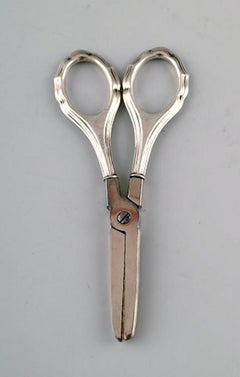 Four Danish and European scissors and tongs in silver, Grann & Laglye 830s.