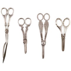Four Danish and European scissors and tongs in silver, Grann & Laglye 830s. 