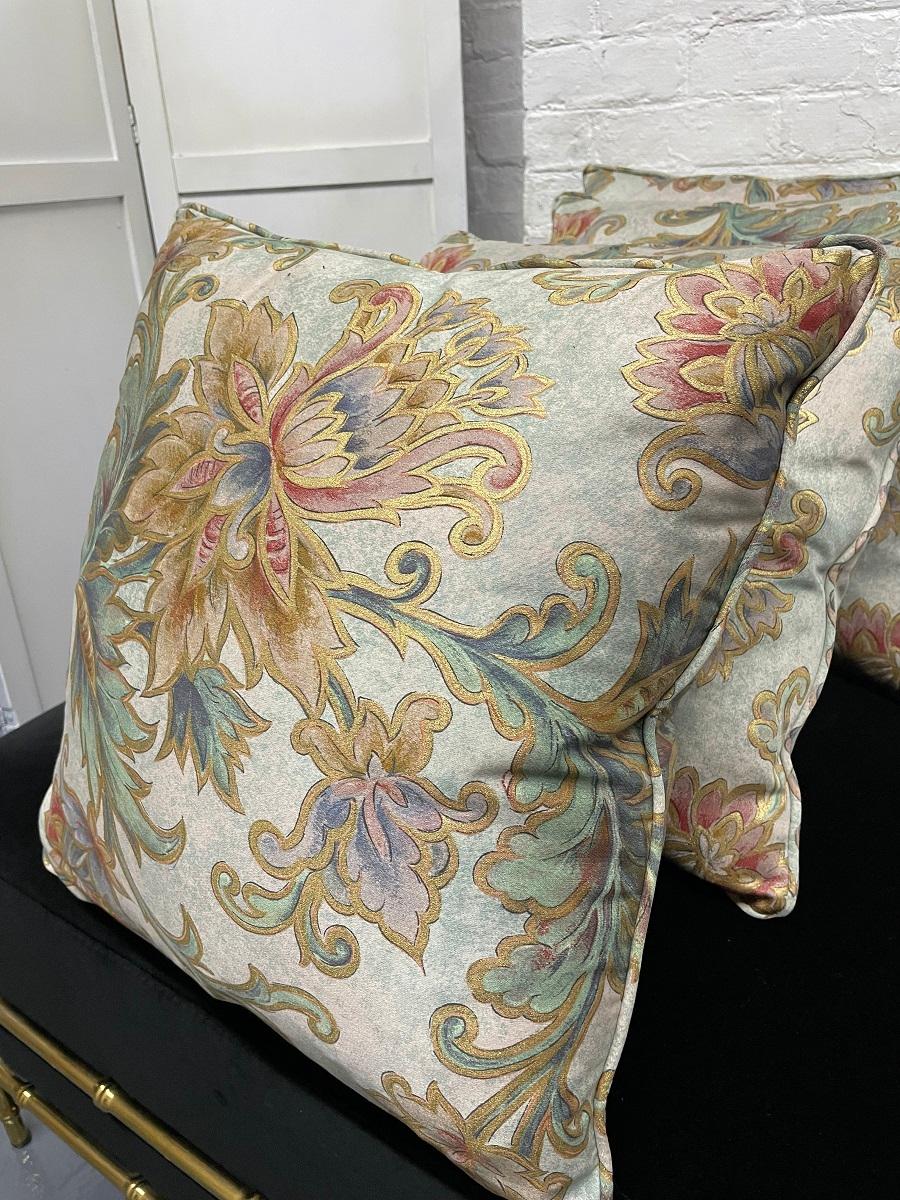 Four Decorative silk pillows. The pillows are silk with a floral pattern. The contents of the cushions are 50/50.