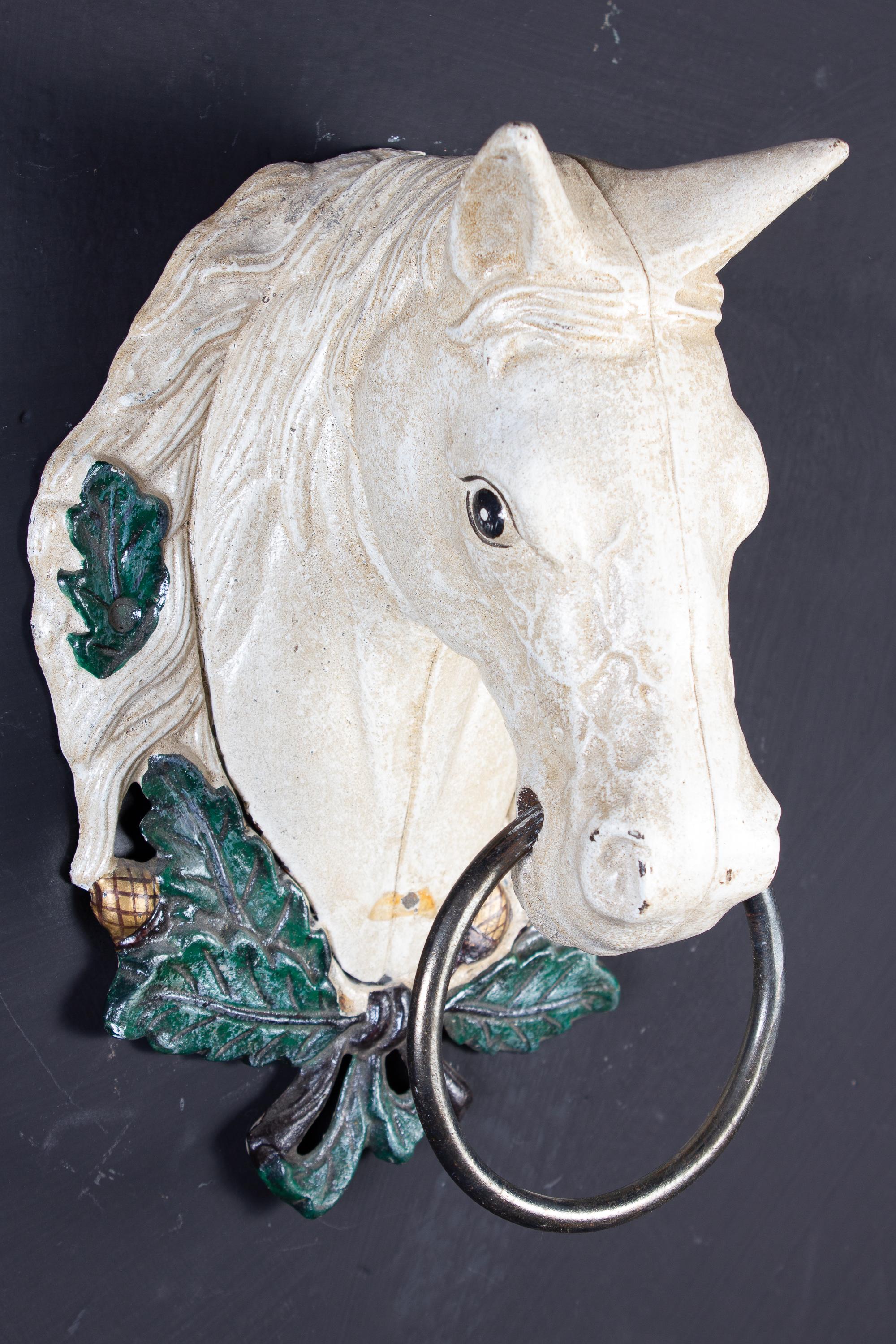 A set of four painted metal horse head sculpture decoration. 
Proveniente from a charming Tuscany country estate. 
We can sell also separately.