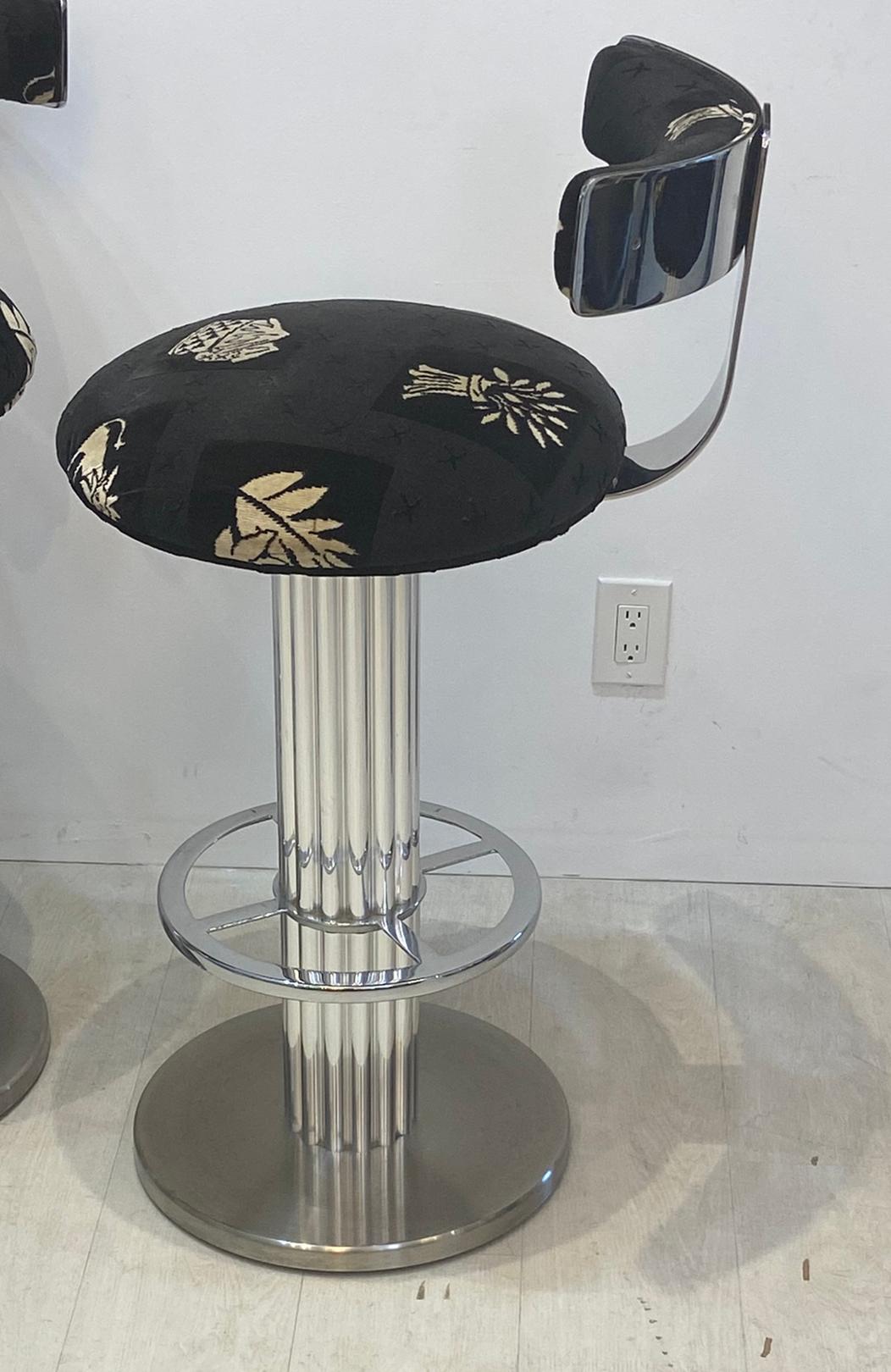 Set of four Design for Leisure bar stools. In very good condition. Upholstered with black fabric with whimsical figures and design. Fabric in very good usable condition. From a well cared for estate.