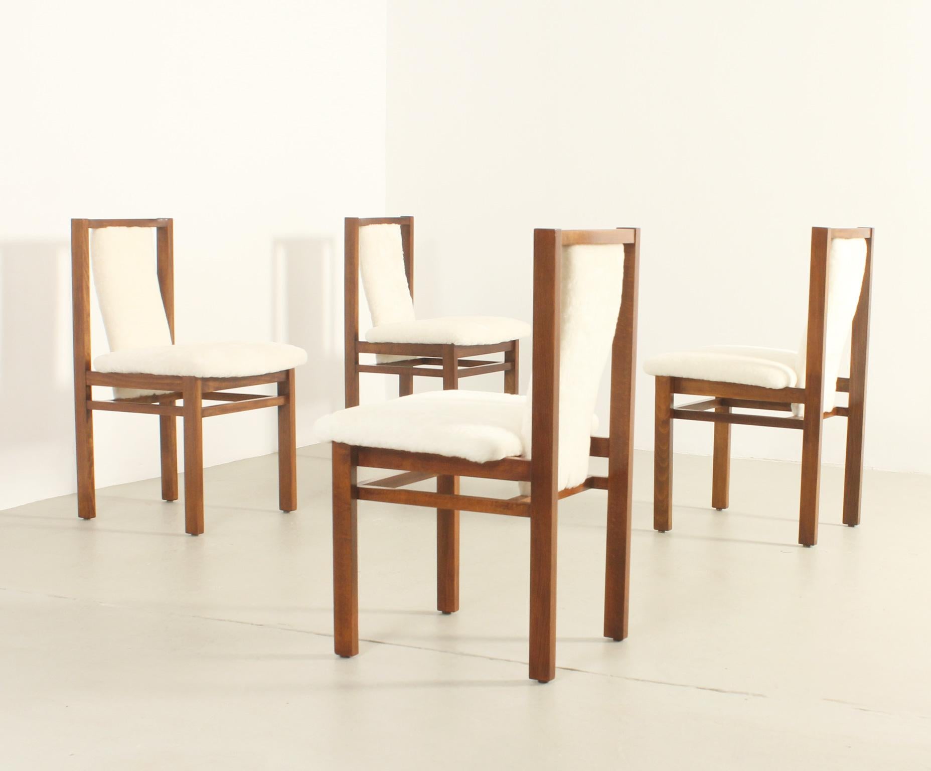 Set of four dining chairs by Jordi Vilanova, Spain, 1960's. Stained oak wood frame and new upholstery with sheepskin.
