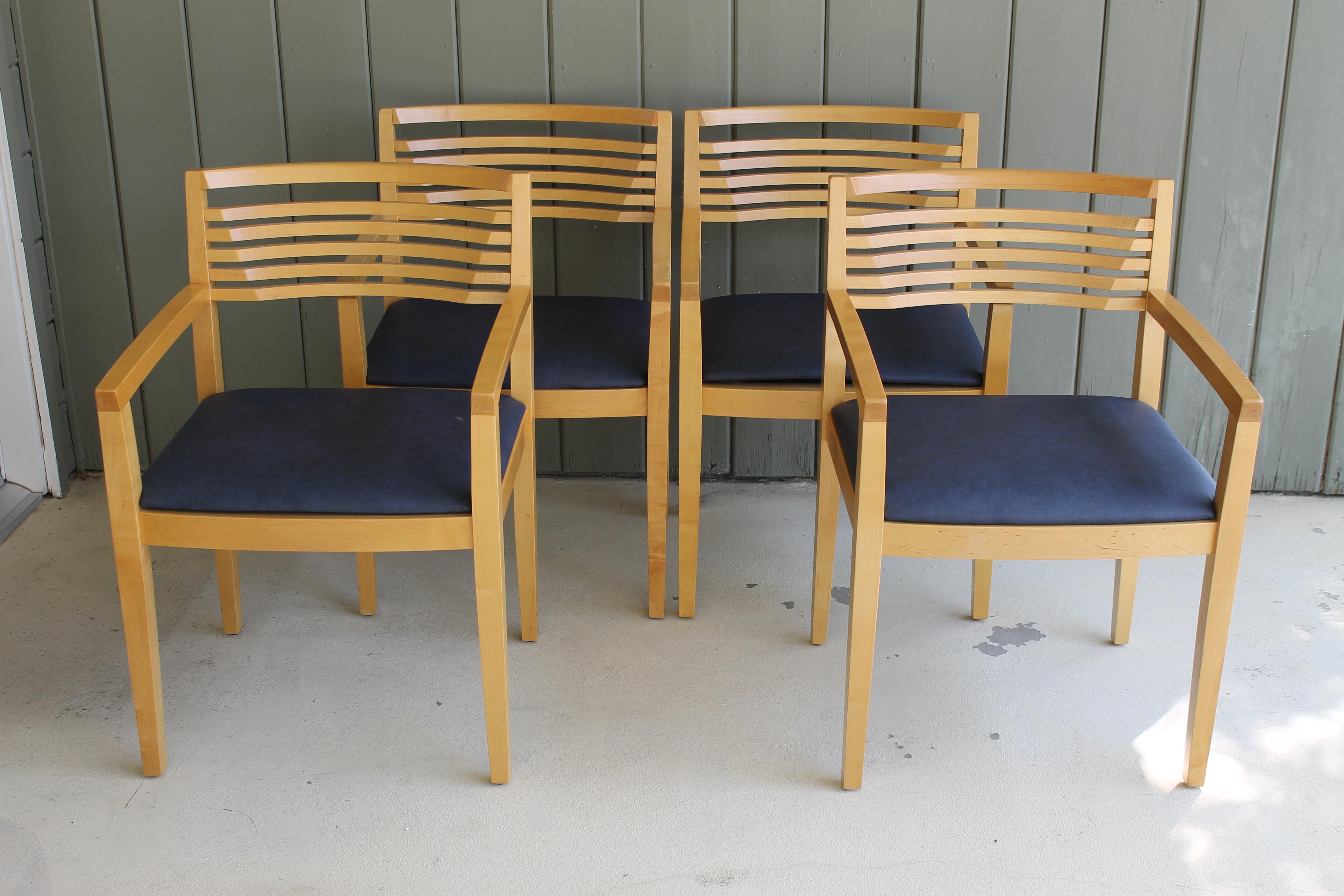 Four armchairs by Linda and Joseph Ricchio and distributed by Knoll, Inc. Solid beechwood with tapered armrests and scooped backs. Each chair measures 21.5