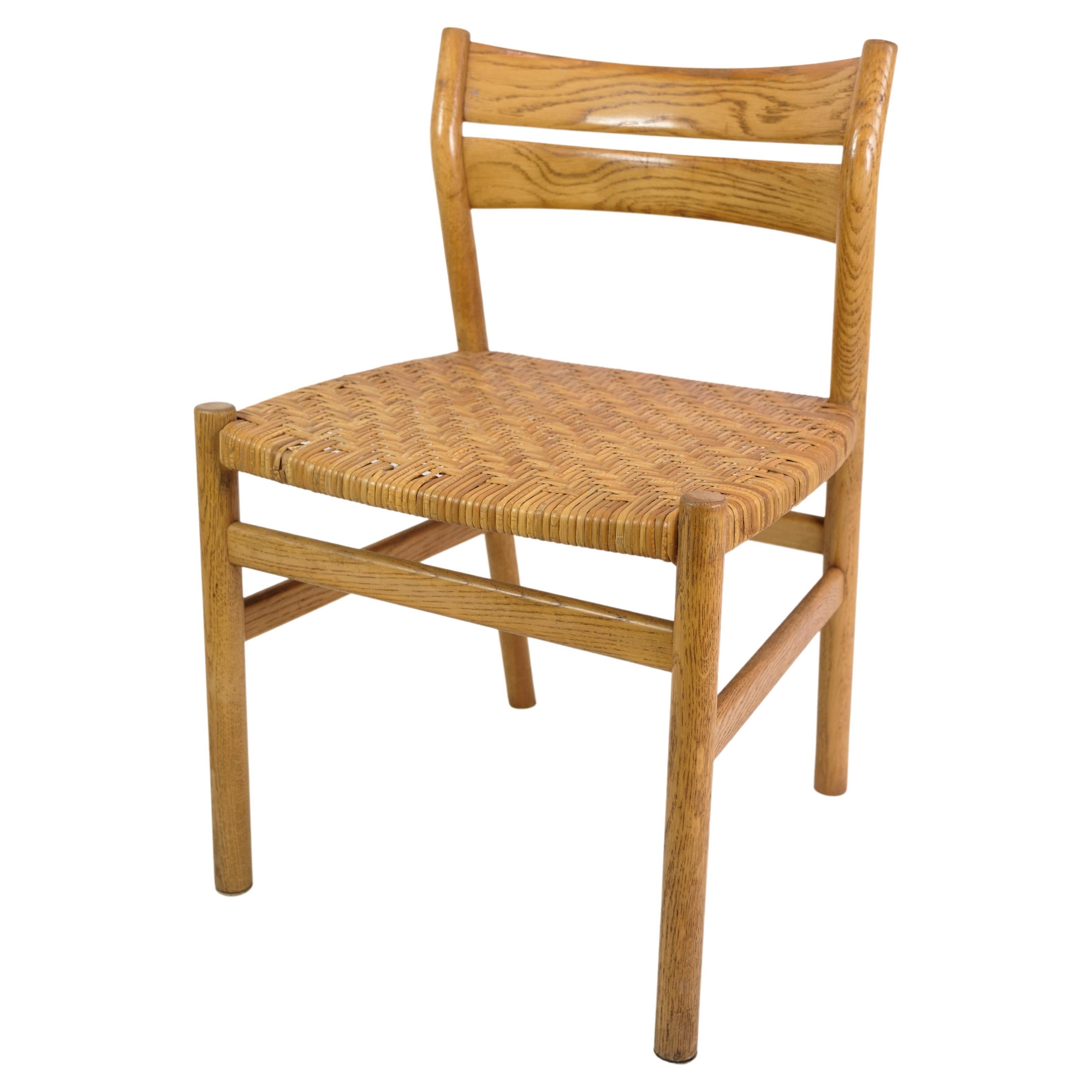 Set of four dining chairs in oak and seat in wicker, designed by Børge Mogensen and produced by C.M Madsen Møbelfabrik in the 1960s. The chairs are in nice vintage condition. Their simple and timeless design makes them suitable for a range of