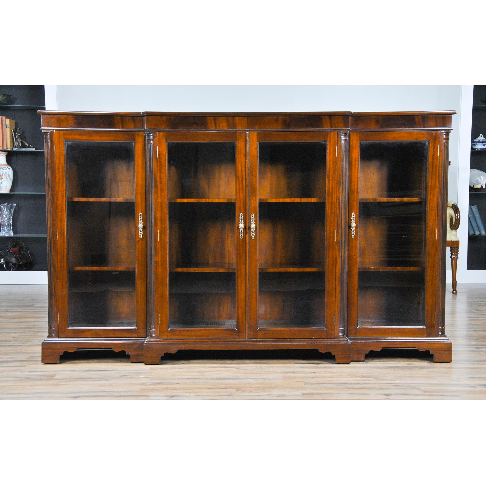 Our version of a breakfront bookcase, this is the Niagara Furniture Four Door Bookcase. The shape of the piece with the center section protruding past the side sections gives it a depth and character not found in most antique reproductions. With