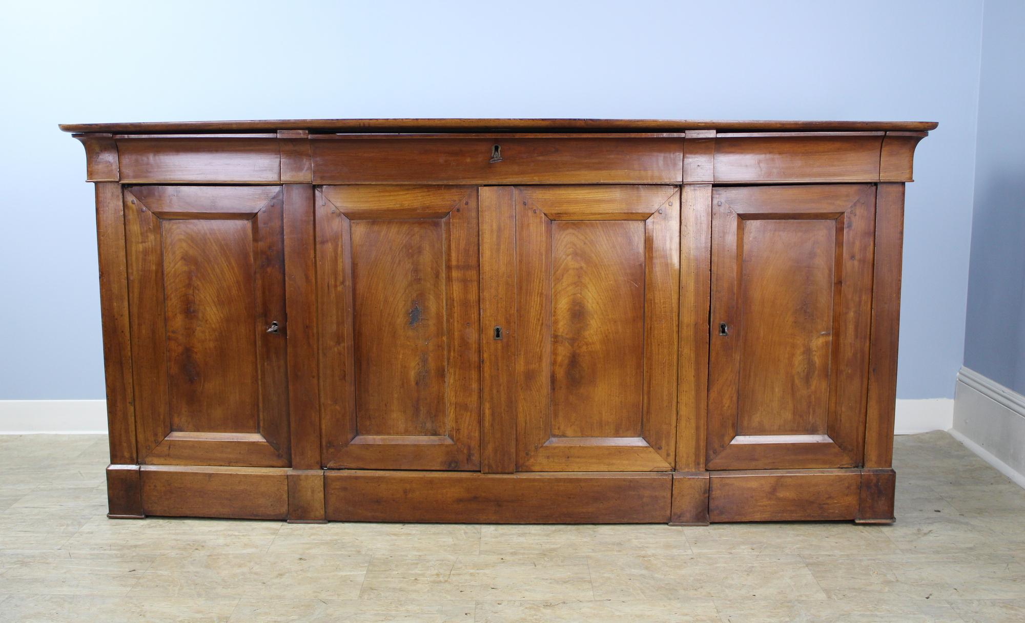 This is a wonderful example of the Louis Philippe style, with shaped drawers, set-in panels on the doors and sides, and perfectly shaped bottom moldings, which are very lovely. The lighter, warm cherrywood color is rich in patina. Good storage, and