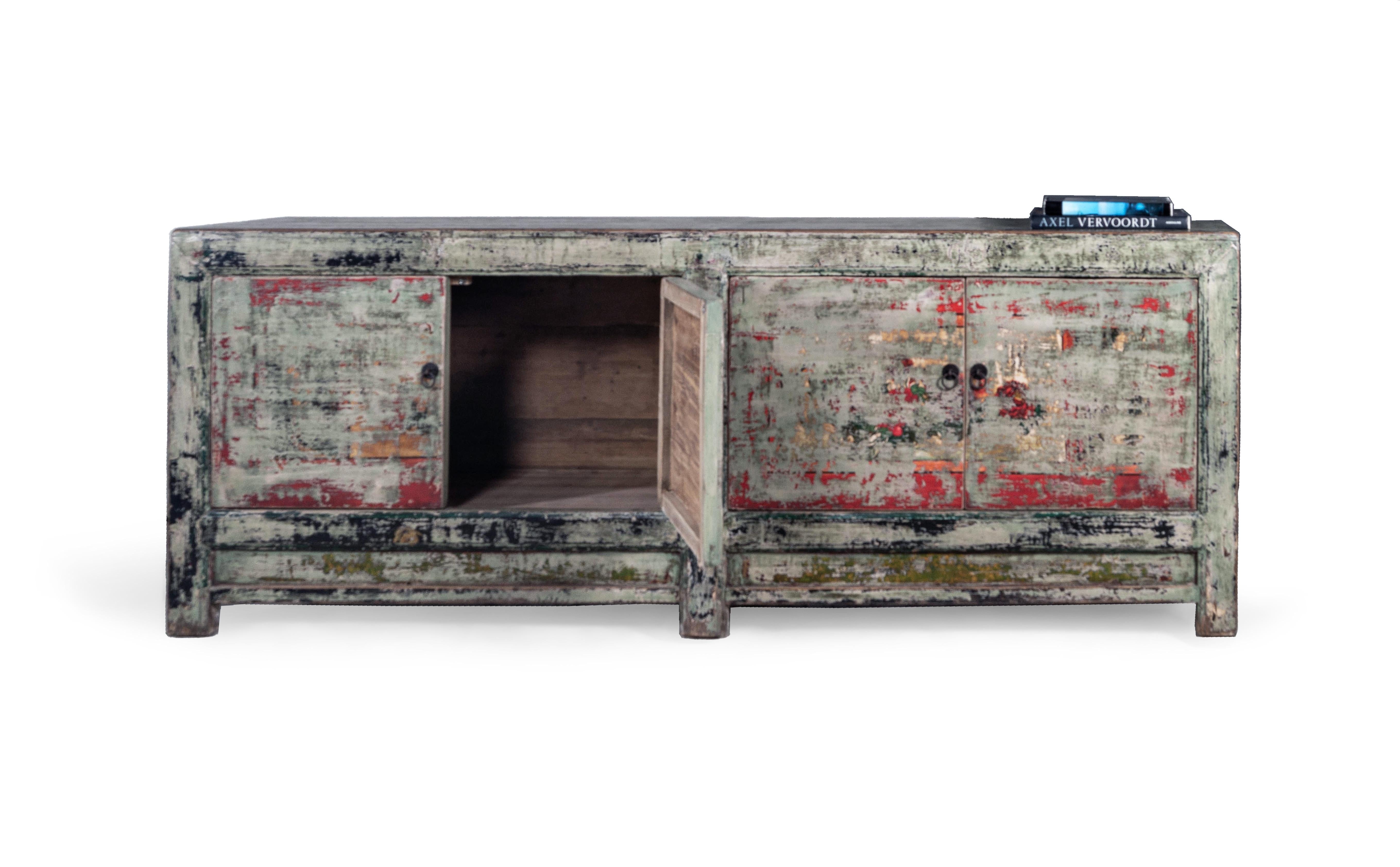 This beautiful one of a kind piece is a the perfect celebration of color and contrast featuring a primarily green paint finish distressed to expose other colors such as red, yellow, and orange. This server is undoubtebly a statement piece for a room