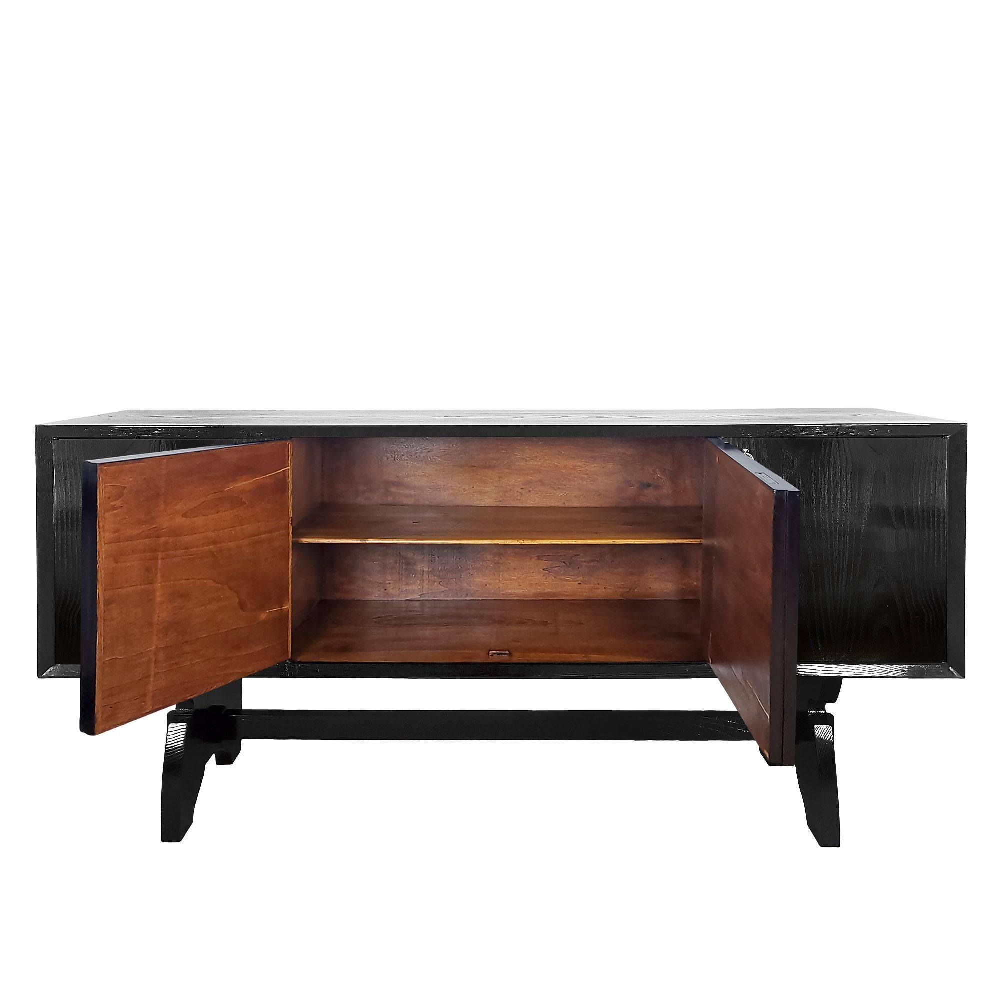 Four-door sideboard in blackened oak veneer resting on two joined struts, woodwork in central doors, walnut-stained interior, nickel-plated brass keys. “Open pore” shellac finish.

Attributed to Paolo Buffa,

Italy c. 1940.