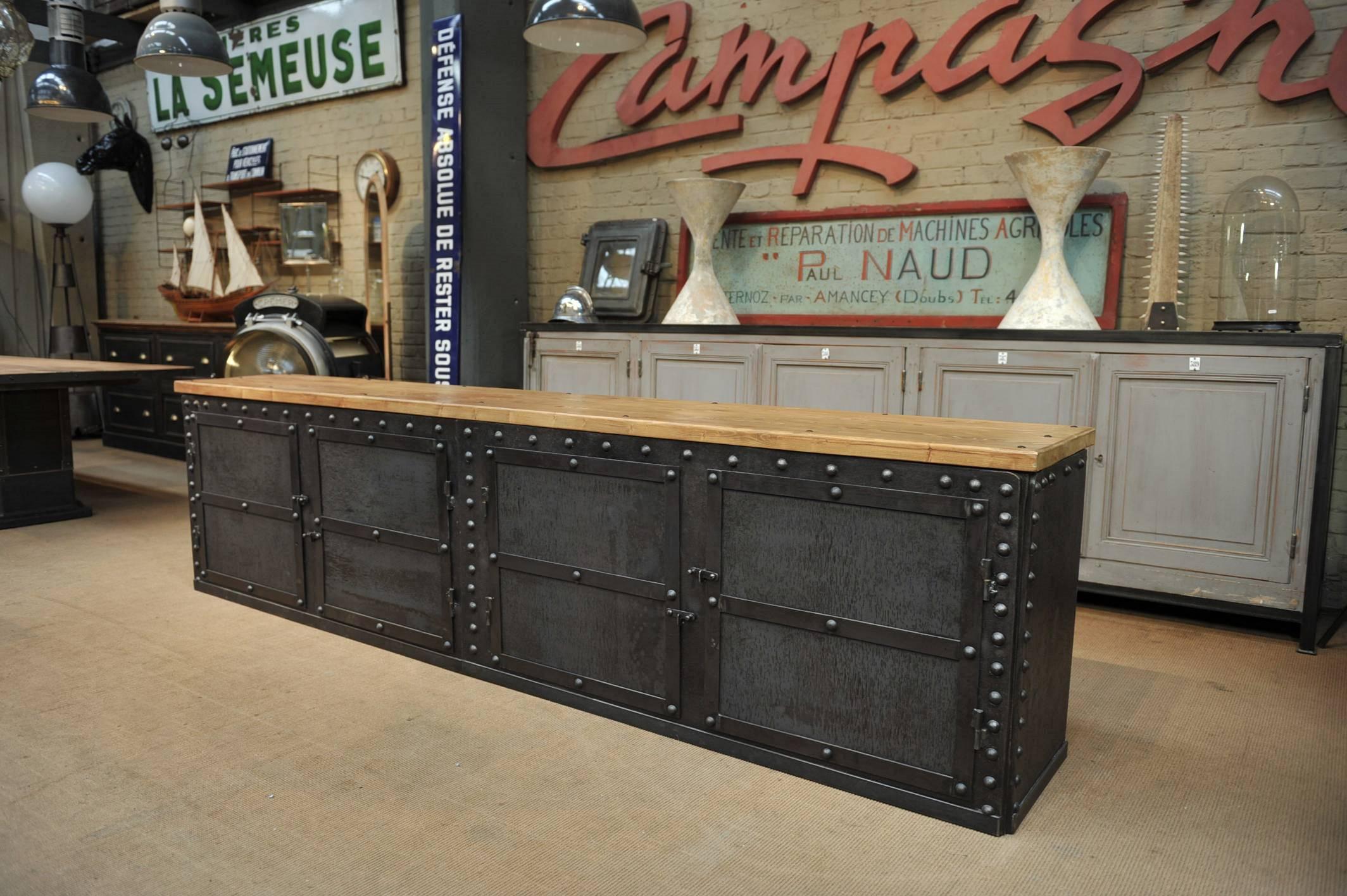 1900 riveted iron French factory trunk opened in four doors long credenza cabinet with solid oak inside shelves and pine top.

 