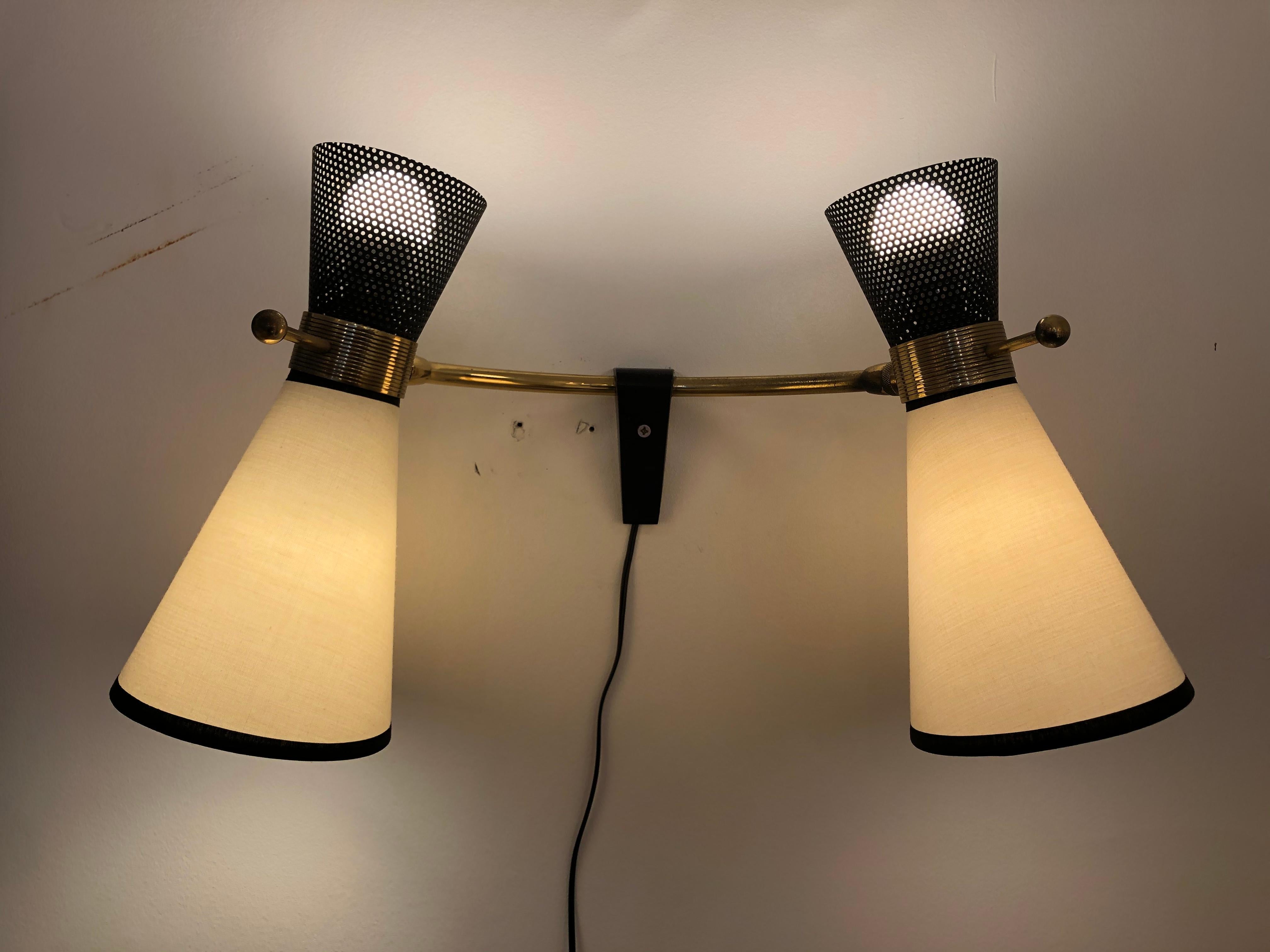 Four double adjustable wall lights by Arlus
from 1950
brass and black lacquered metal.
  