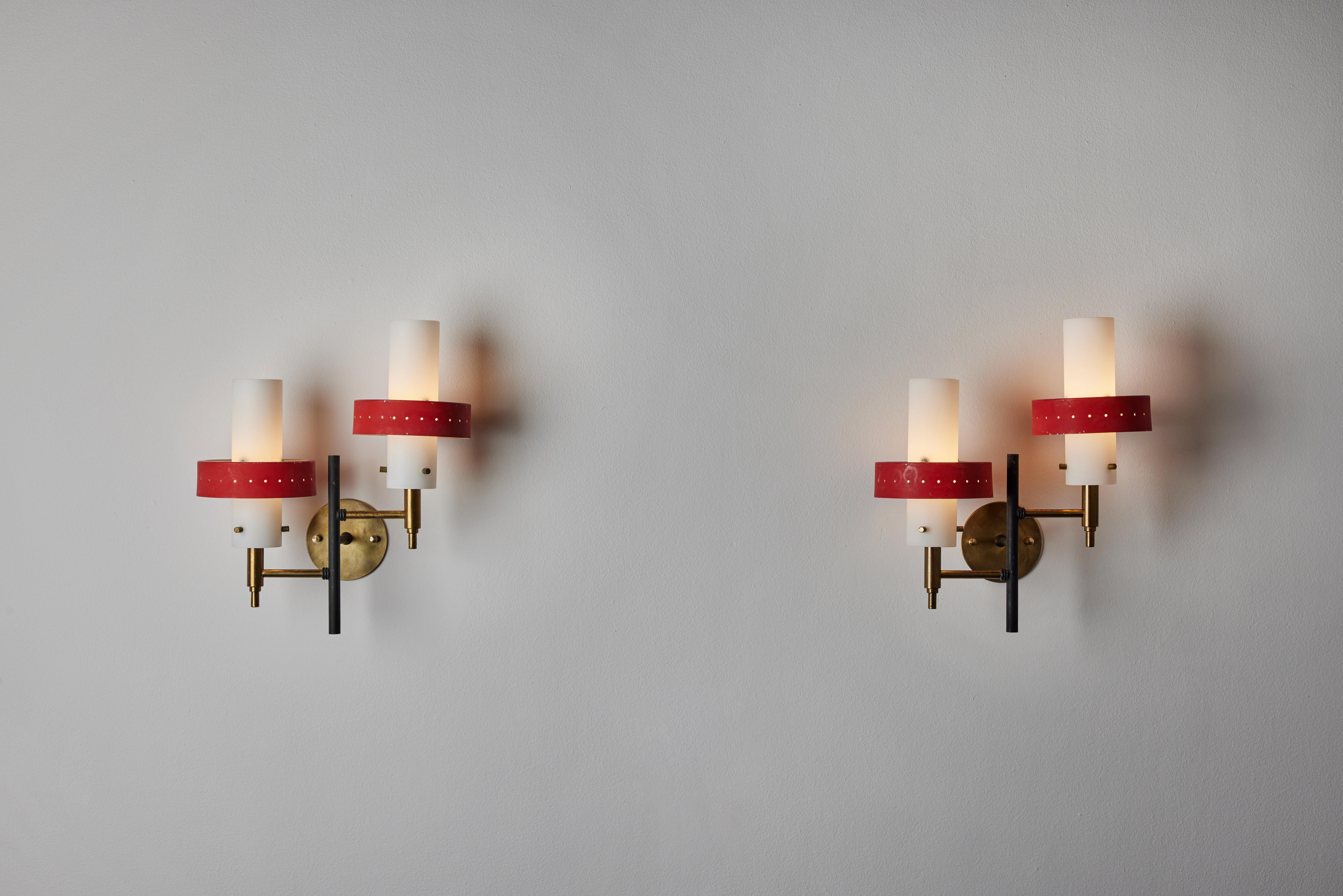 Two double arm sconces by Stilnovo. Manufactured in Italy, circa 1950's. Brushed satin glass diffusers, painted metal armature, custom brass backplates. Manufactured in Italy, circa 1950's. Wired for U.S. standards. We recommend two E14 60w maximum
