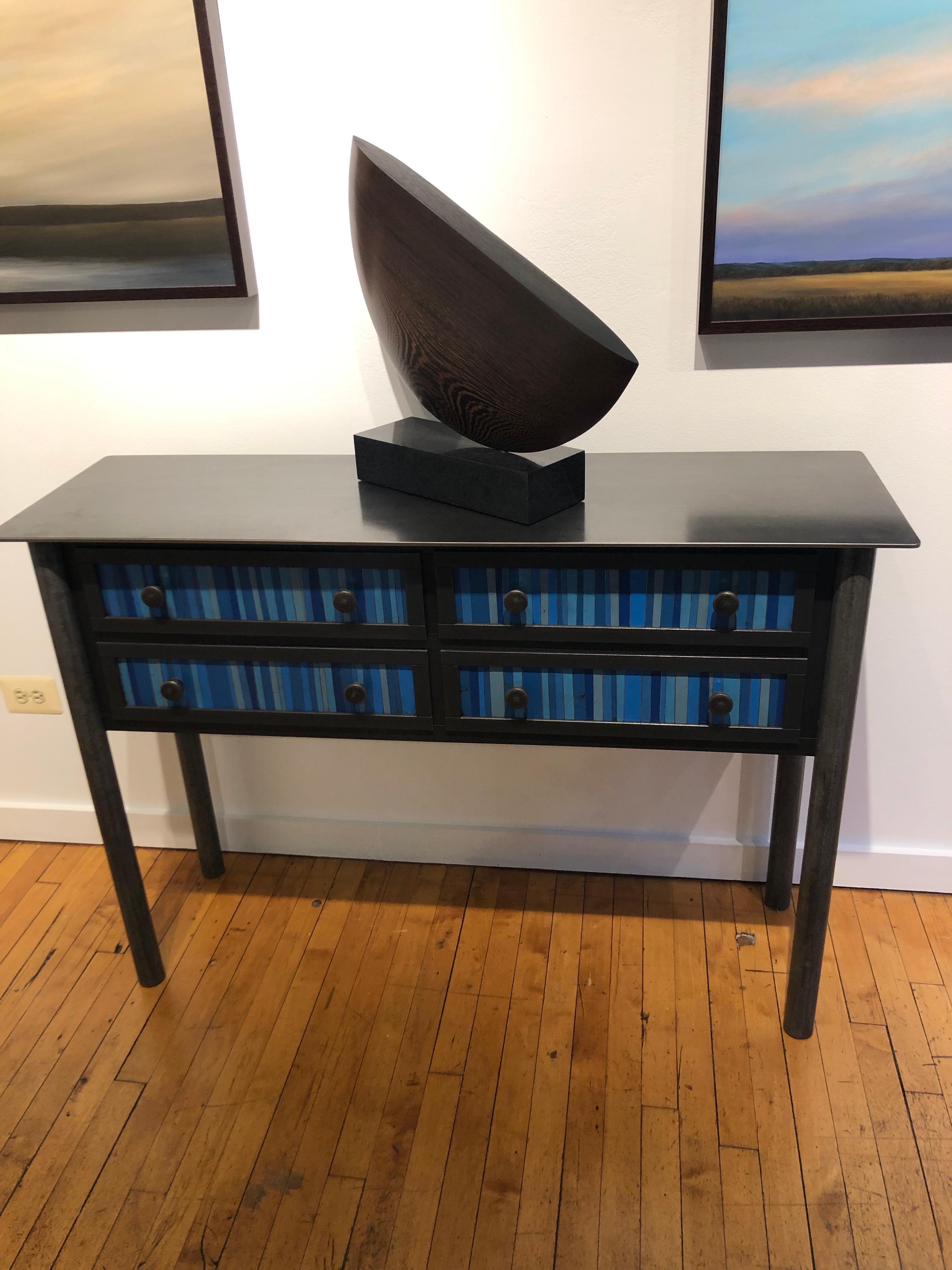 This totally functional modern industrial cabinet is created from hot-rolled steel and found painted panels. The panels on the drawer fronts and sides are created from strips of blue painted salvaged and recycled steel. This unique custom piece is a