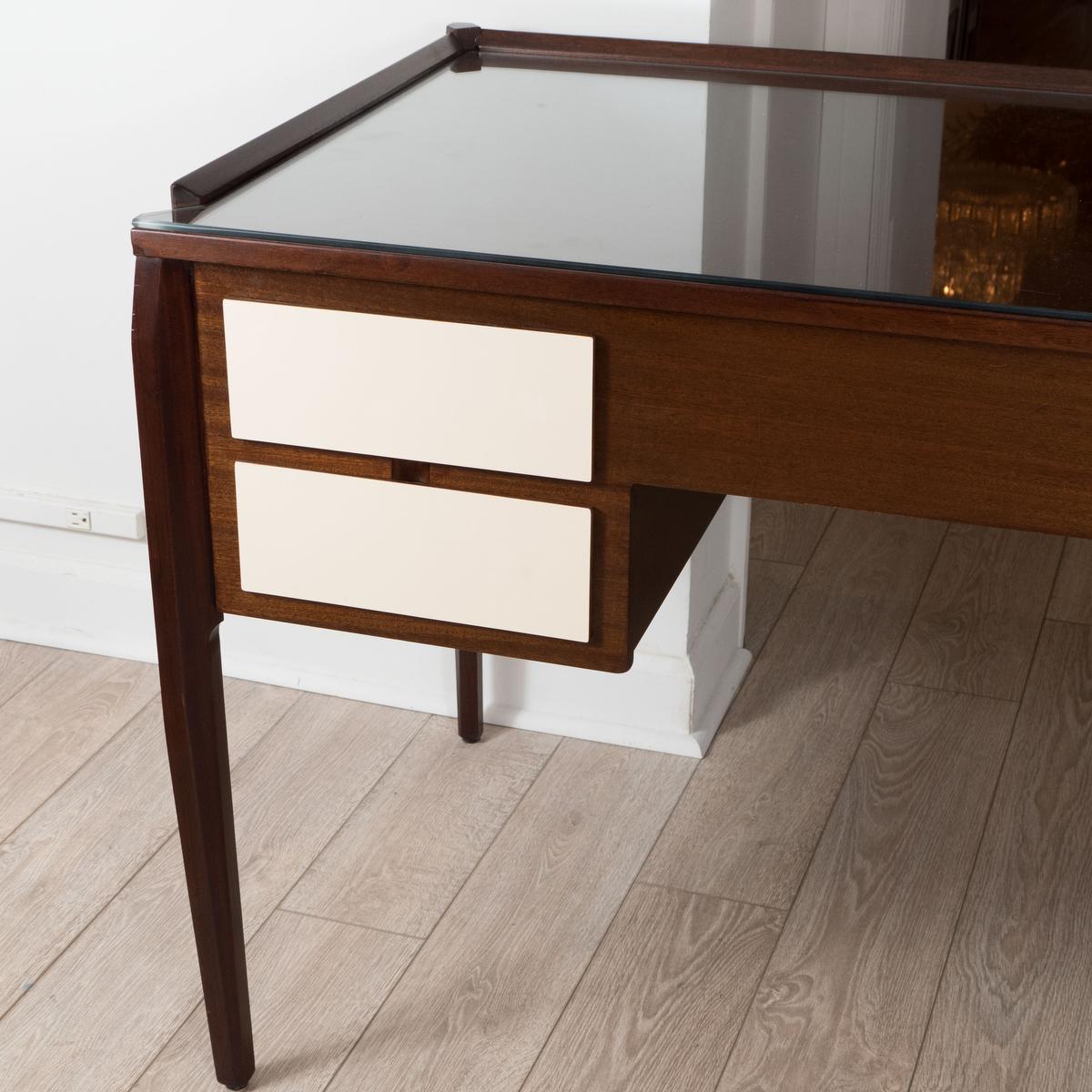 Four drawer wood desk with ivory lacquered drawers and angular legs in the style of Gio Ponti.