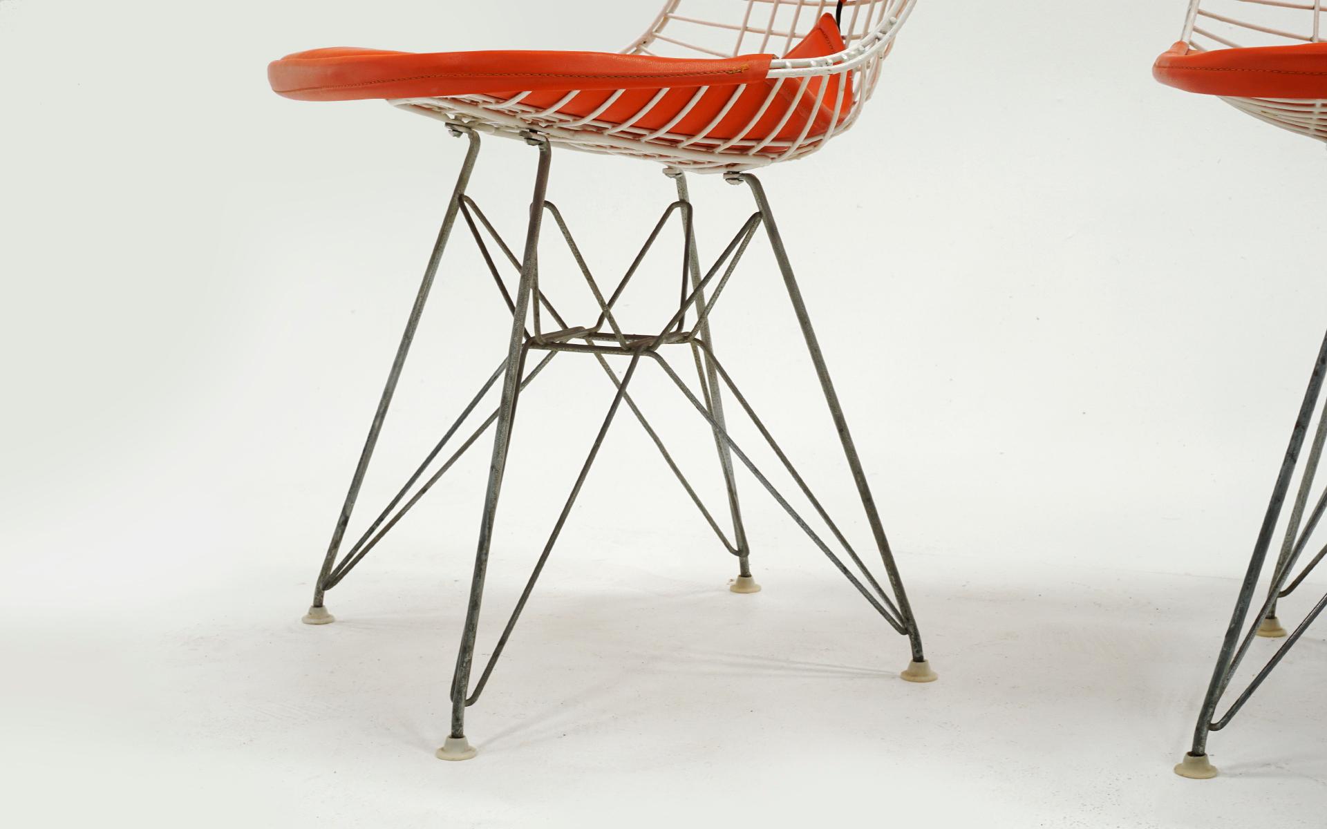 Four Eames White Wire DKR Dining Chairs, Eiffel Tower Base, Orange Bikini Covers 1