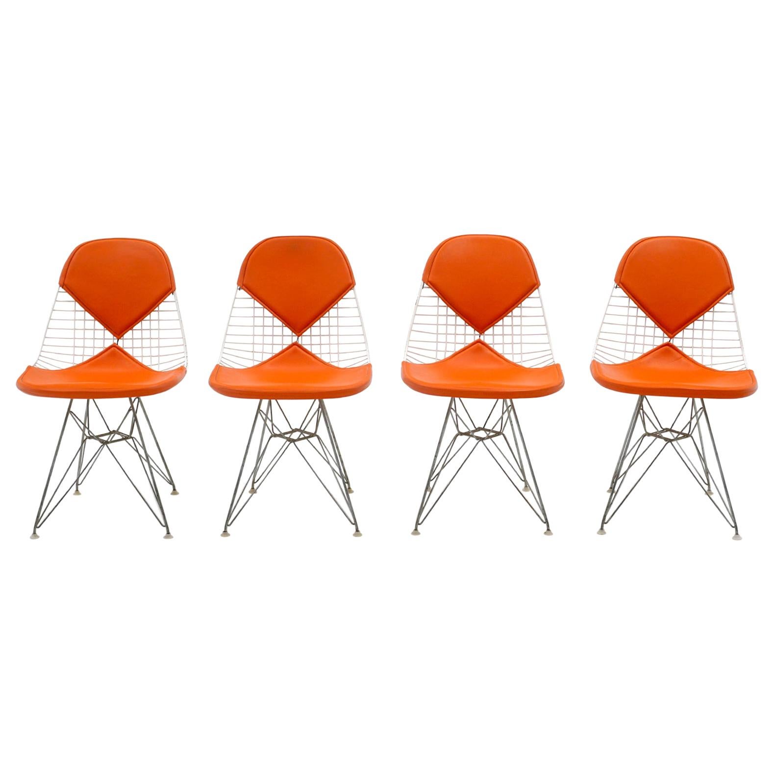 Four Eames White Wire DKR Dining Chairs, Eiffel Tower Base, Orange Bikini Covers