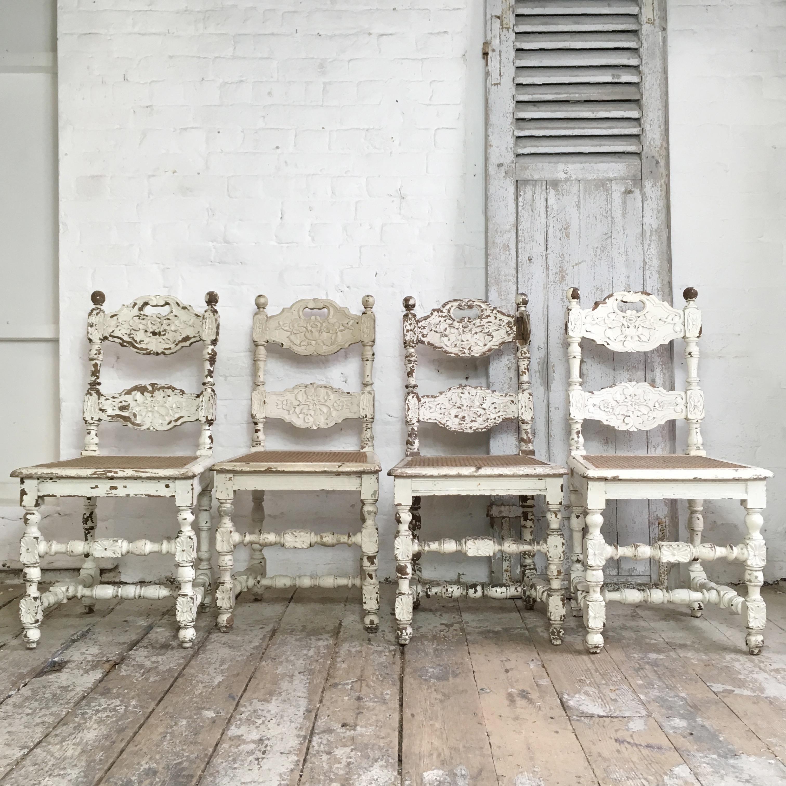 Set of four early 19th century French carved oak dining chairs.
The price is for the set of four chairs. 
Intricate and heavily carved dining chairs. 
The chairs have beautiful floral carvings and turned legs with shaped backs and cut out handle