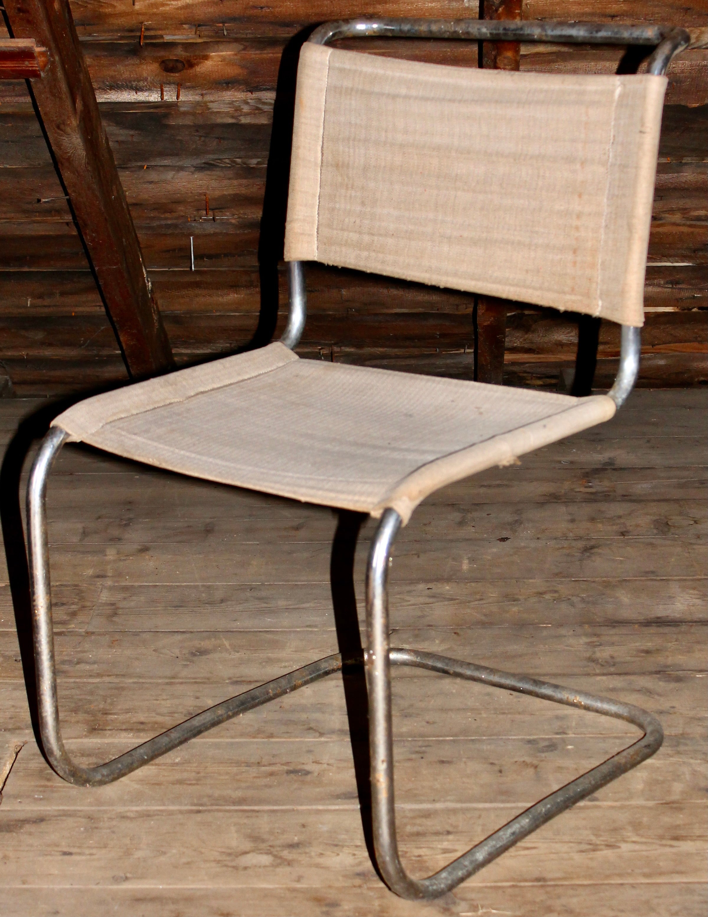 Four original period cantilever canvas and tubular steel side chairs. Manufactured by Thonet or Robert Slezak.