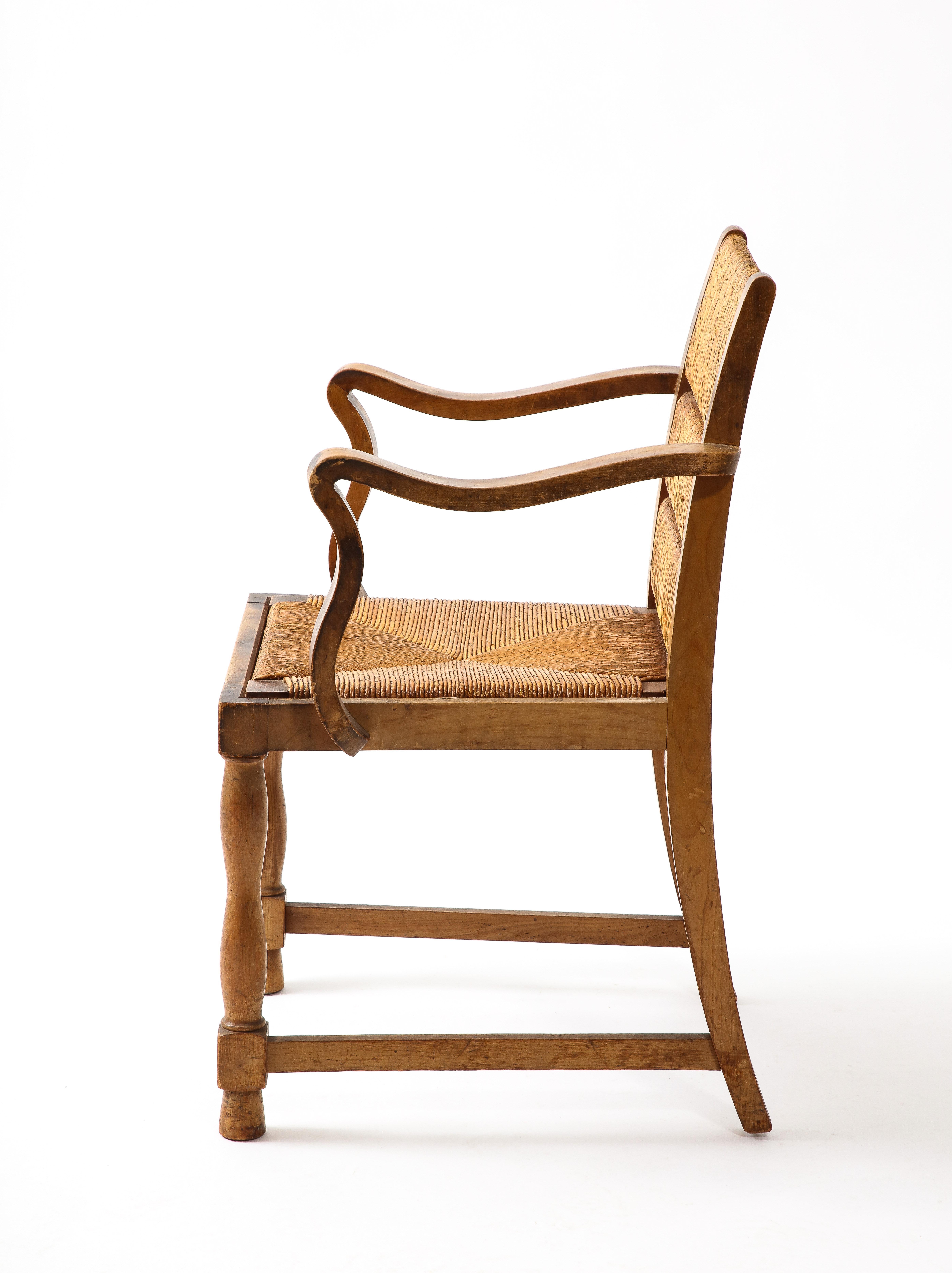 Elégant ensemble de quatre fauteuils en Eleg à accoudoirs en forme de trèfle, les dossiers divisés en sections conservent leur finition d'origine en jonc.