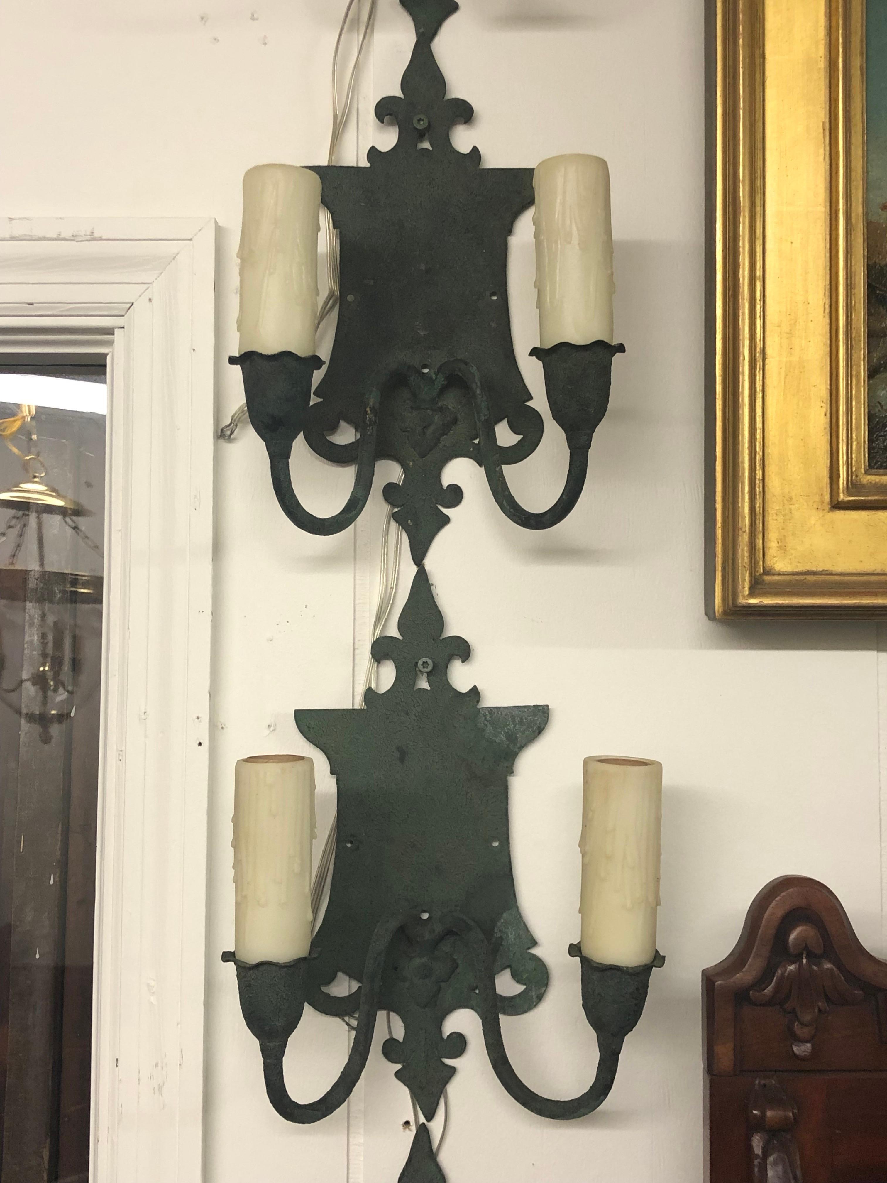 Cet ensemble de quatre appliques Arts & Crafts anglaises en laiton Verde à deux bras a été fabriqué au début du 20e siècle.