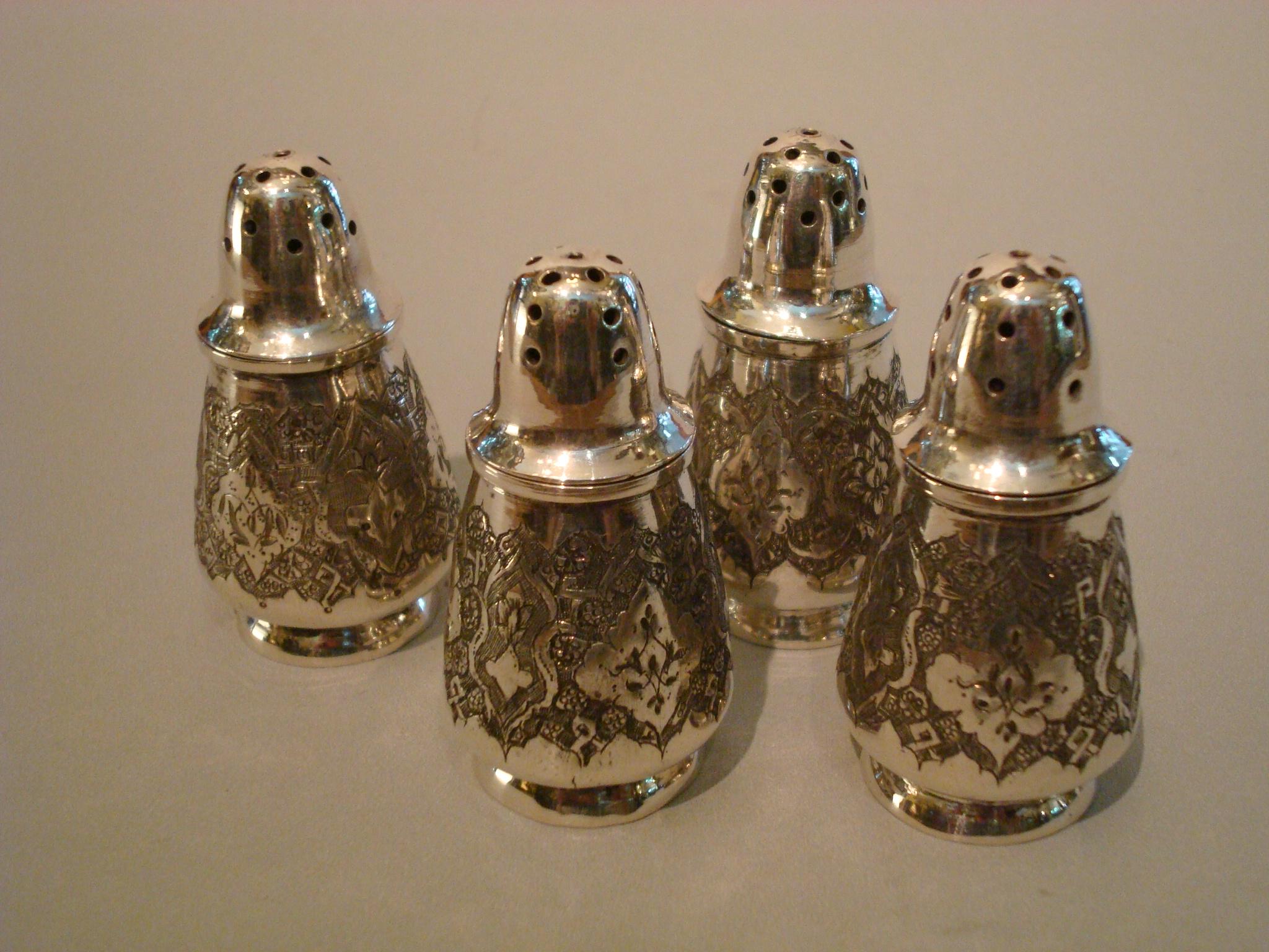 Antique sterling silver salt and pepper shakers.
A set of four engraved Russian/Persian silver salt and pepper shakers.
Made late 19th-early 20th century. Highly decorated with floral motif. Every piece marked 84 (old silver standard) with the
