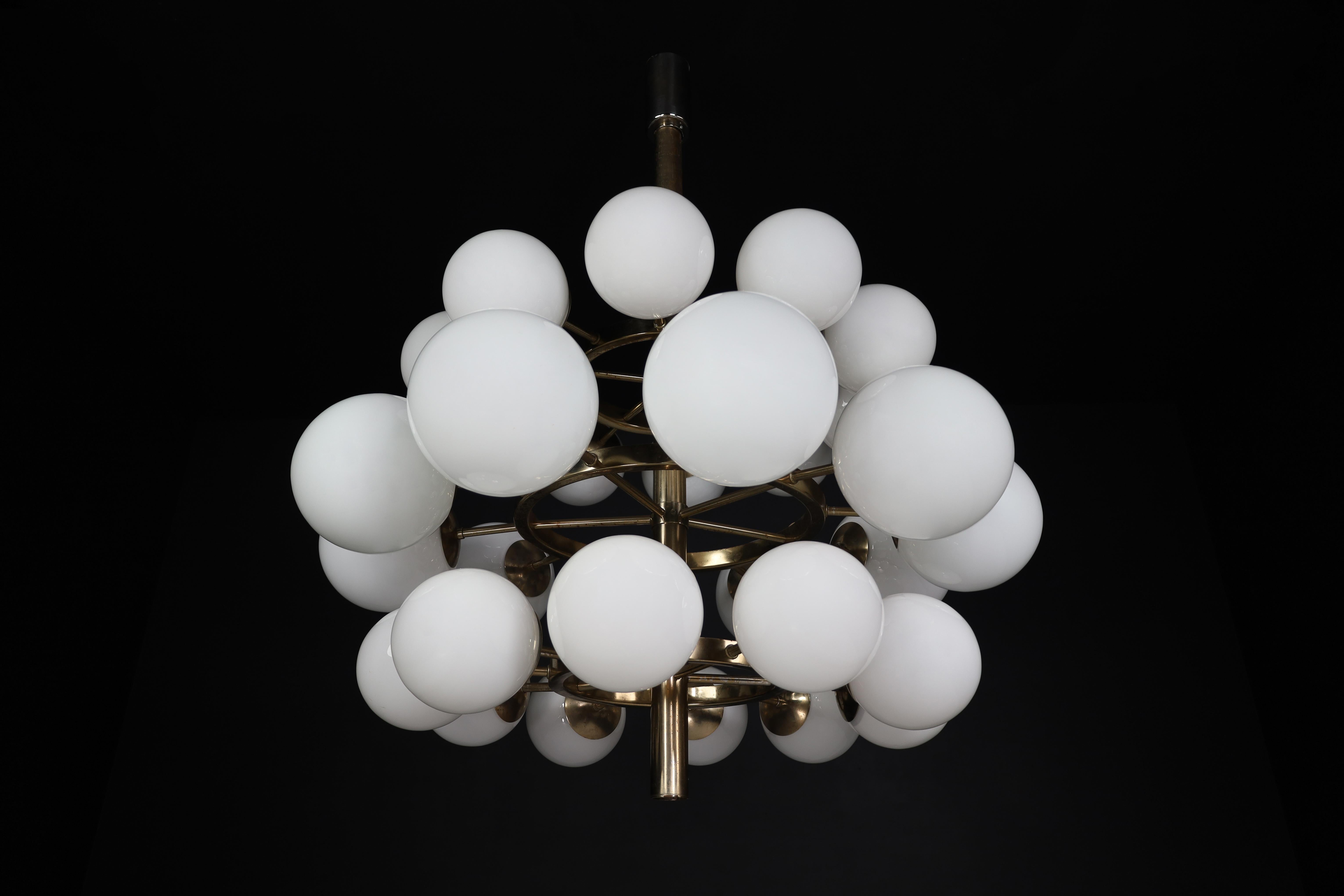A midcentury modernist large chandelier with 30 handblown opaline glass globes. The fixture is made of metal with a chrome-brass patina. Therefore an attractive color is visible on the metal. Thirty opaline glass globes are placed over three levels.