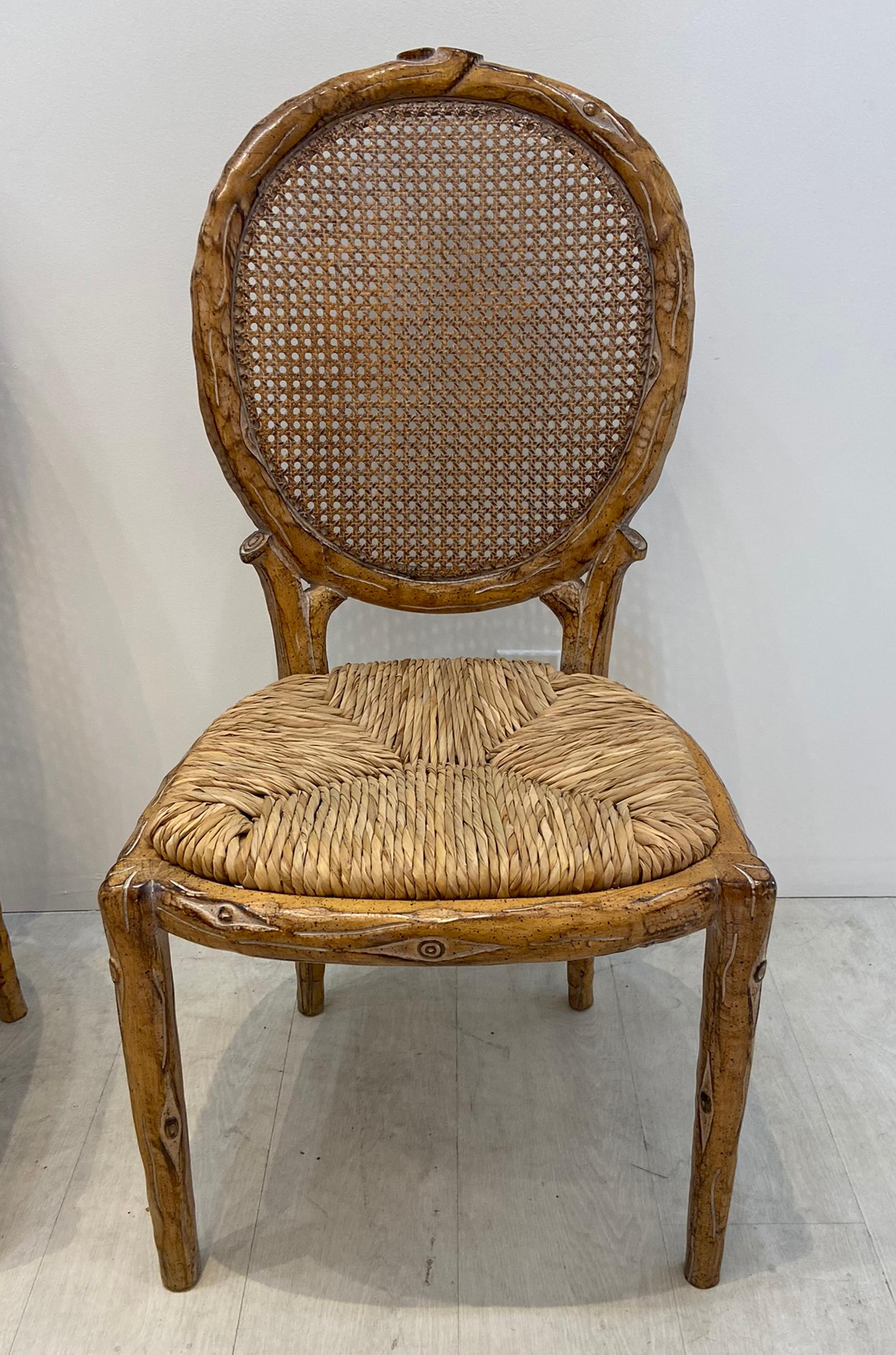 Faux bois dining chairs made in Spain. Set of four with cane backs and woven rush seats. In very good condition clean with no damage to backs or seats.