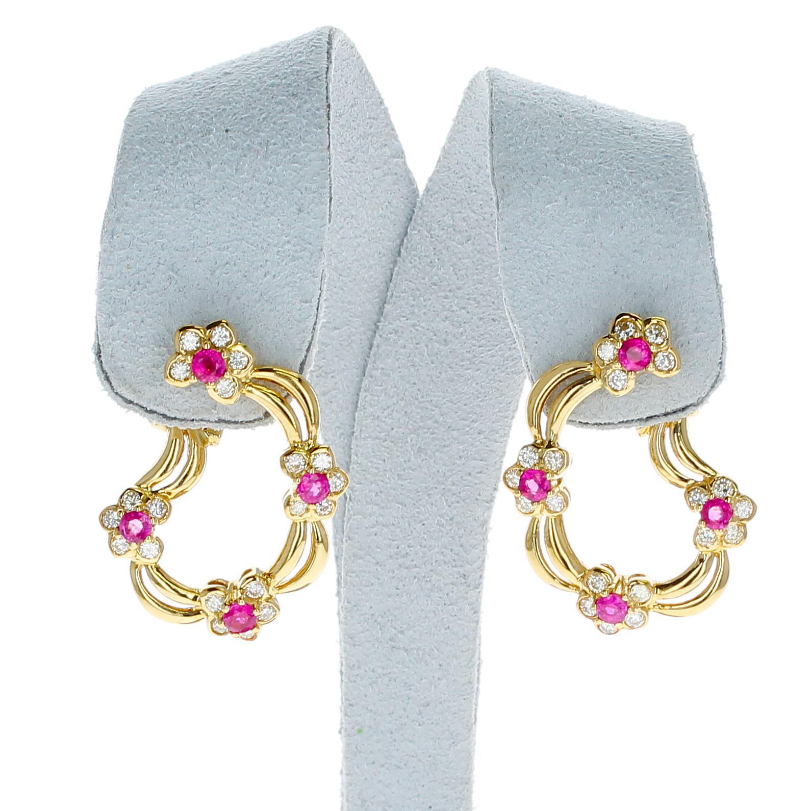 A pair of Four Flower Ruby and Diamond Floral Clip-on Earrings made in 18 Karat Yellow Gold. The total weight of the earrings are 13.25 grams. 