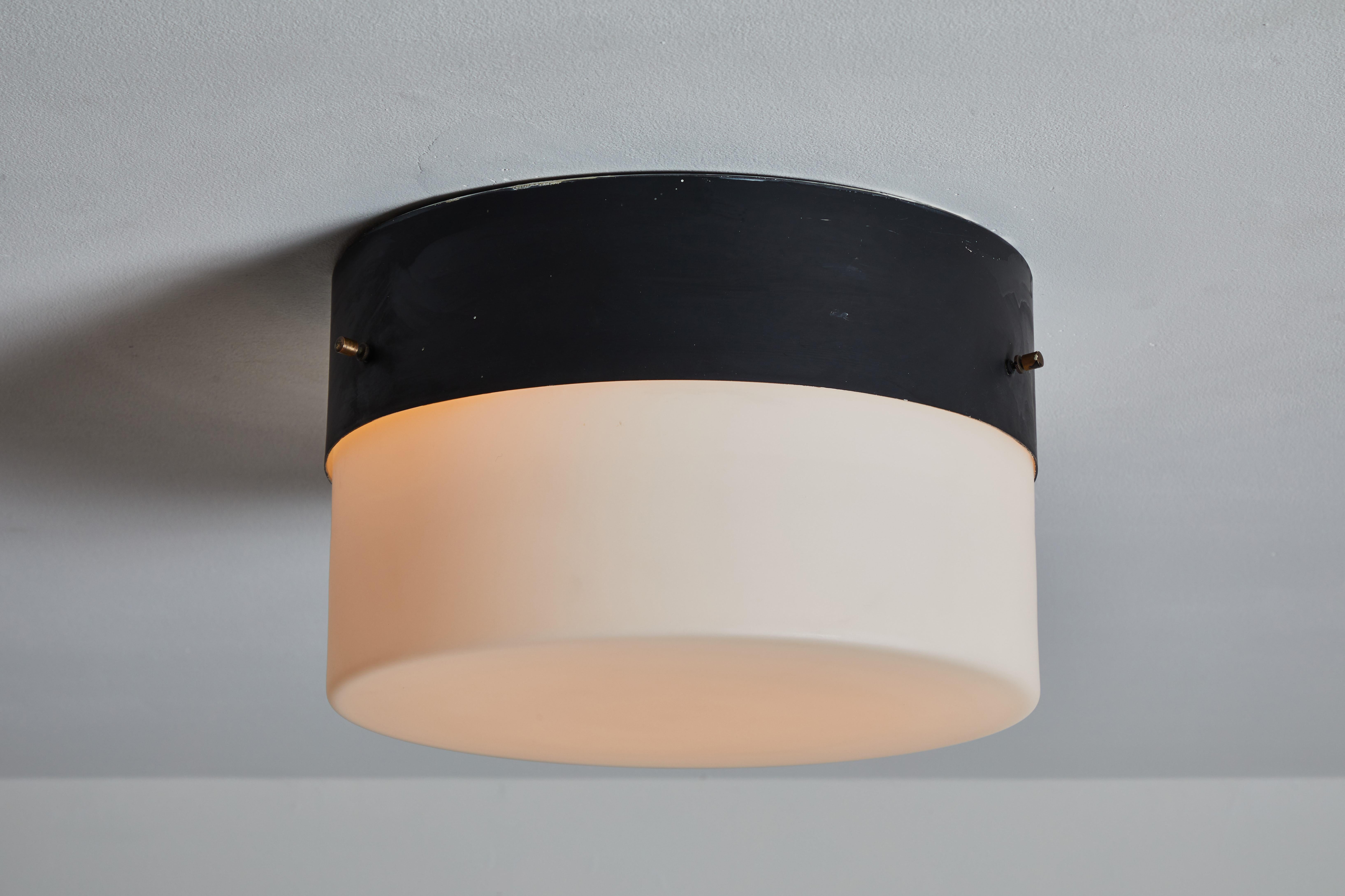 Flush mount lights by Stilnovo. Designed and manufactured in Italy, circa the 1960s. Rewired for U.S. junction boxes. Enameled aluminum with glass diffusers. Each light takes three E27 60w maximum bulbs. Bulbs are provided as a one-time courtesy.