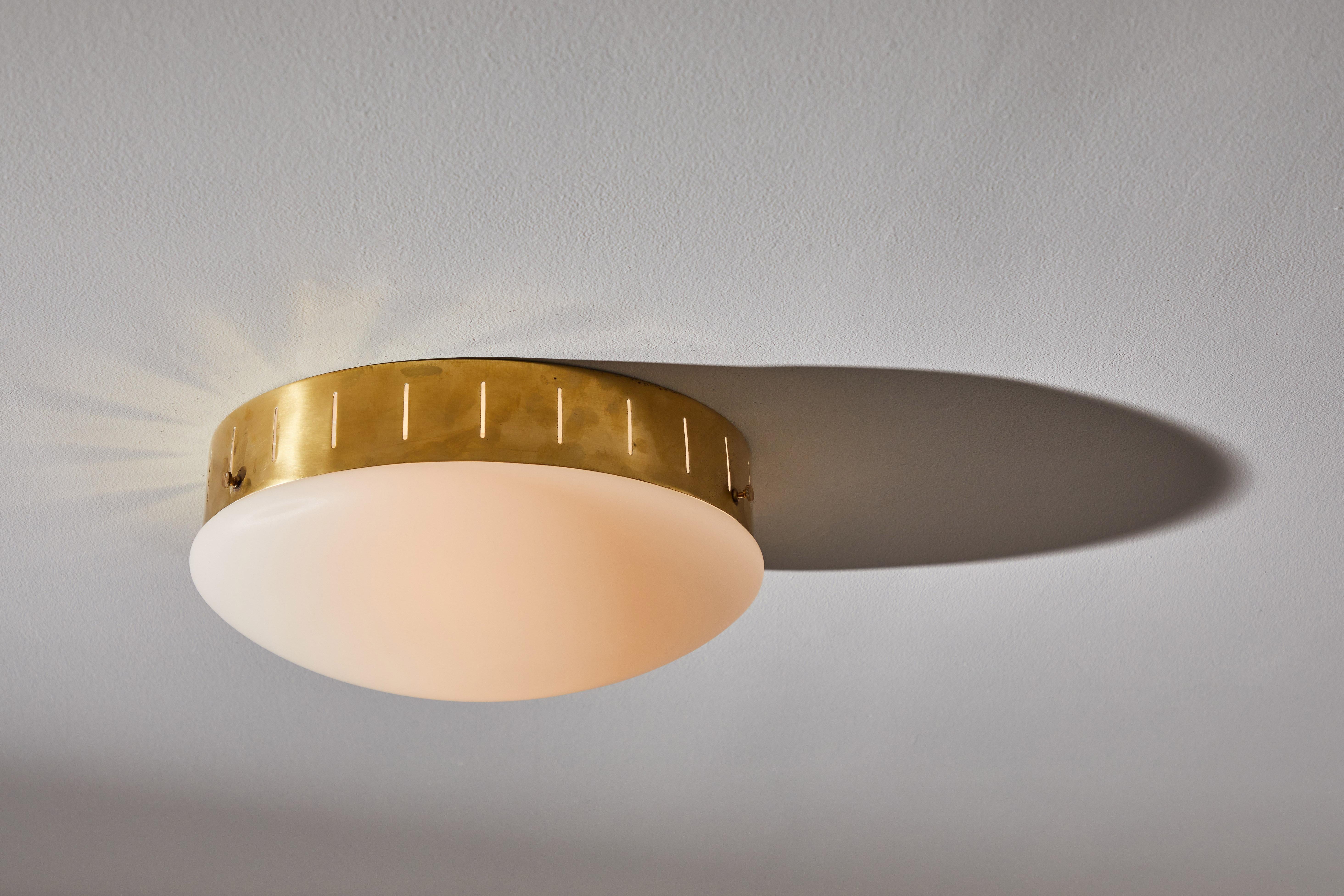Single flushmount ceiling light by Stilux. Designed and manufactured in Italy, circa 1960s. Brass, brushed satin glass diffusers. Rewired for U.S. standards. Light takes one E27 100w maximum bulb. Bulbs provided as a one time courtesy. QTY: 1