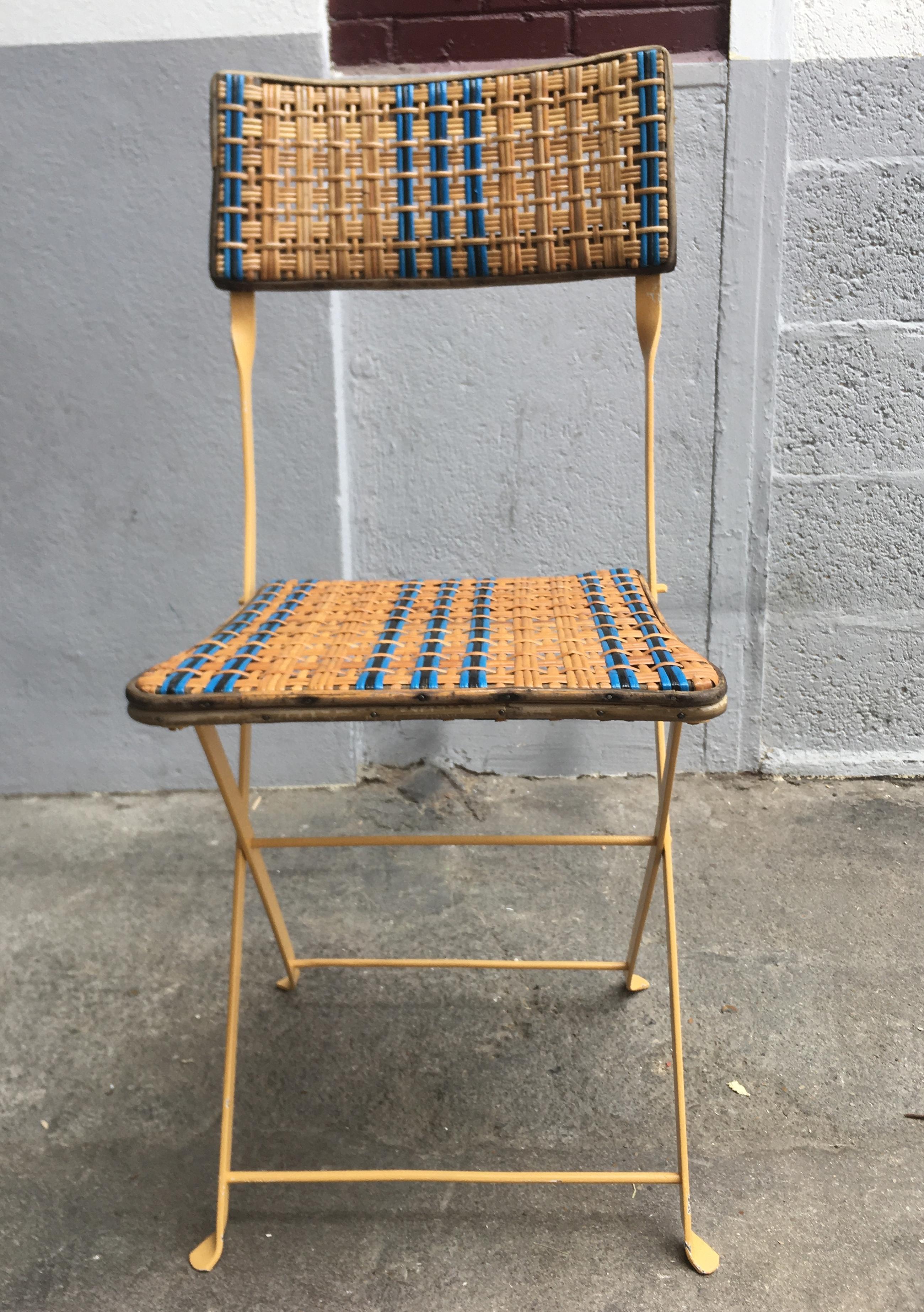 Four garden chairs in woven and lacquered rattan, on an foldable iron structure.