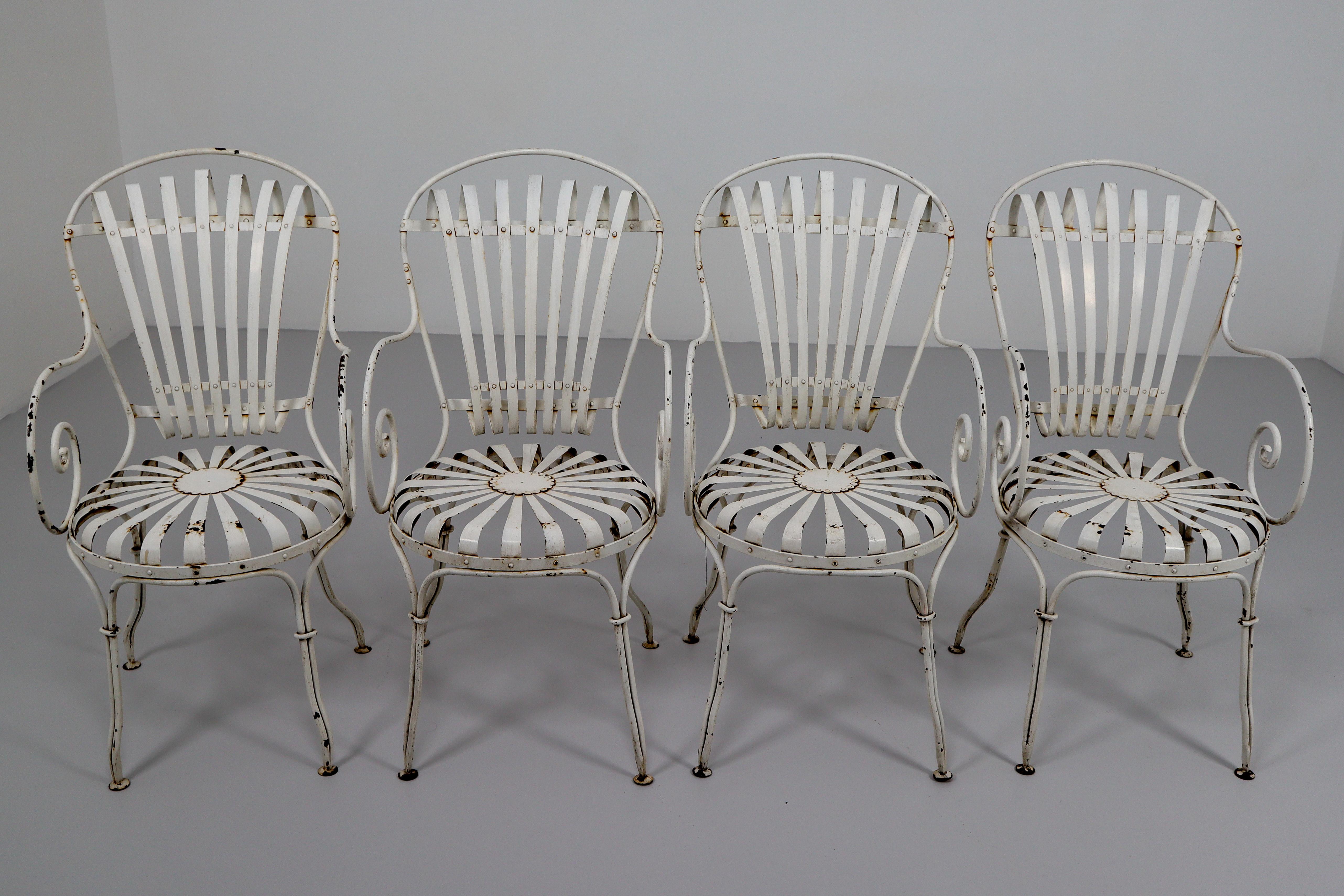 Pair of Four Francois Carre garden chairs manufactured, circa 1930 in France. Metal legs and structure, metal seat and backrest. In good vintage condition with minor wear consistent with a age and use, preserving a beautiful patina. This model of