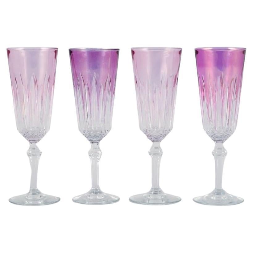Four French champagne flutes in crystal glass. Classic design in purple glass.