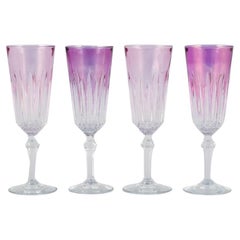 Four French champagne flutes in crystal glass. Classic design in purple glass.