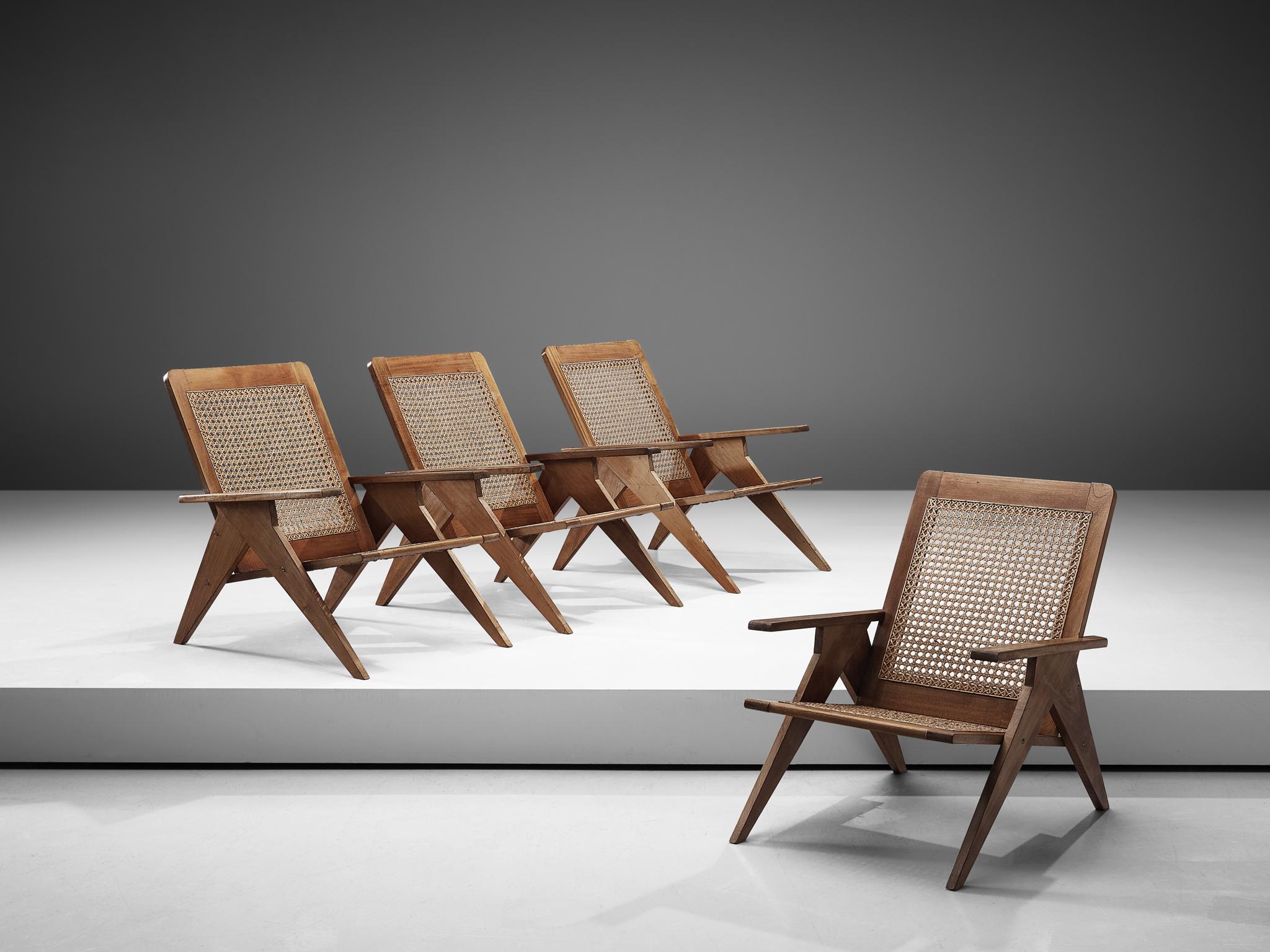Set of 4 lounge chairs, cane and mahogany, France, 1960s

This set of French lounge chairs shows wonderful, sculptural details. The straight armrests and the tapered, triangular shaped legs combine beautifully with its woven cane seat. The chairs