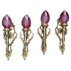 Four French Rococo Revival Gilt Bronze Wall Lights with Cranberry Cut Glass