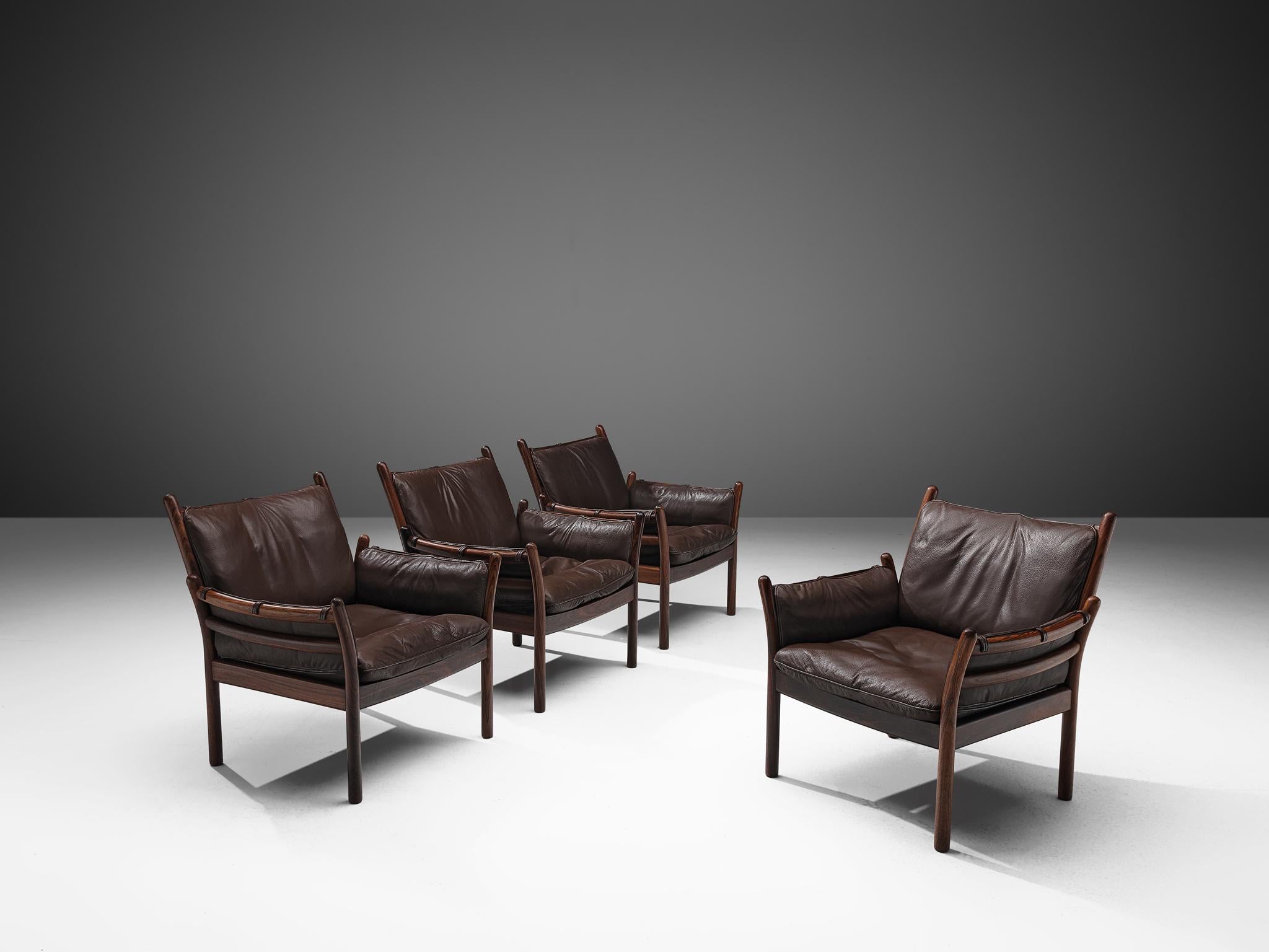 Illum Wikkelsø by CFC Silkeborg, four 'Genius' armchairs, leather and rosewood, Denmark, 1950s.

This chair is made out of solid rosewood and features a cognac leather cushion on both seat and back. The chair is created as a sort of slatted