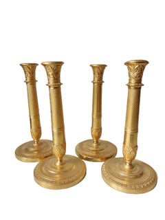 Four Gilded Early 19th Century French Candlesticks