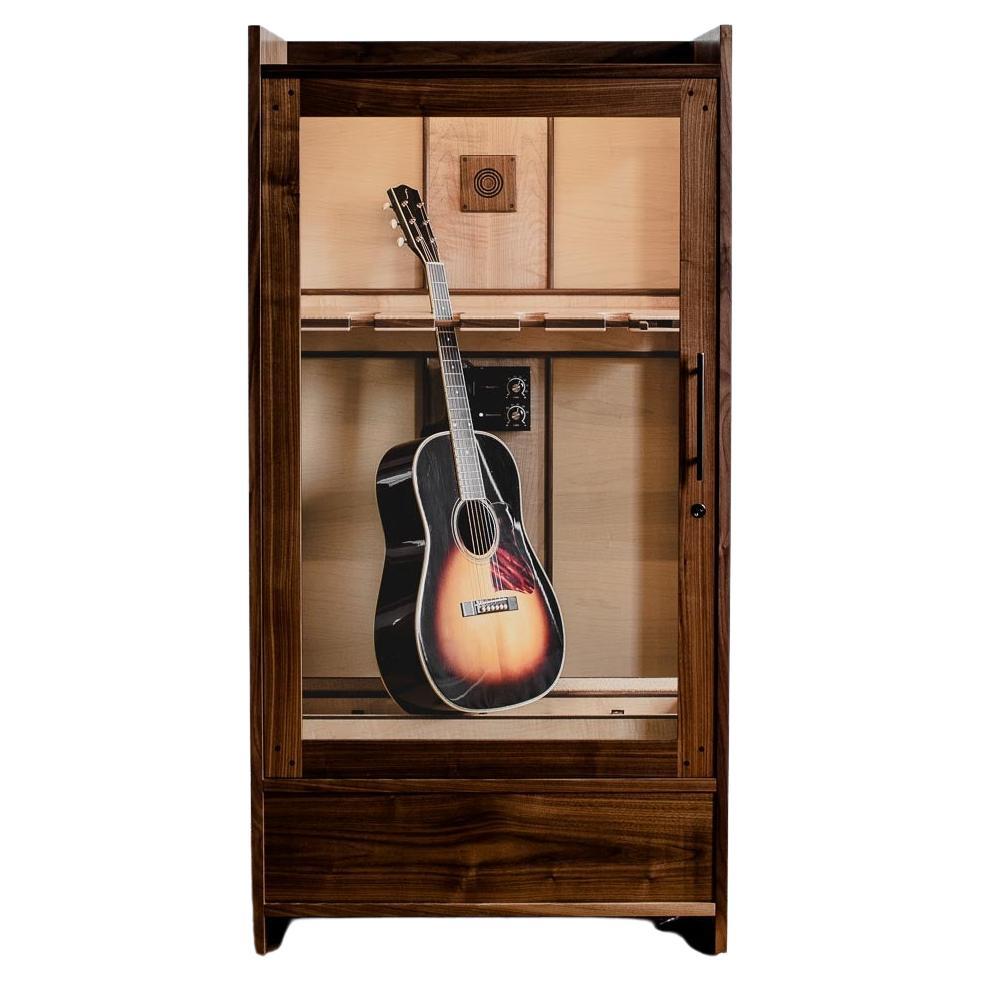 The Guitar Habitat is a handcrafted solid wood cabinet and guitar humidor designed to display acoustic and electric guitars in an easily accessible & elegant four-guitar display. This humidified guitar display cabinet includes a 1-gallon guitar