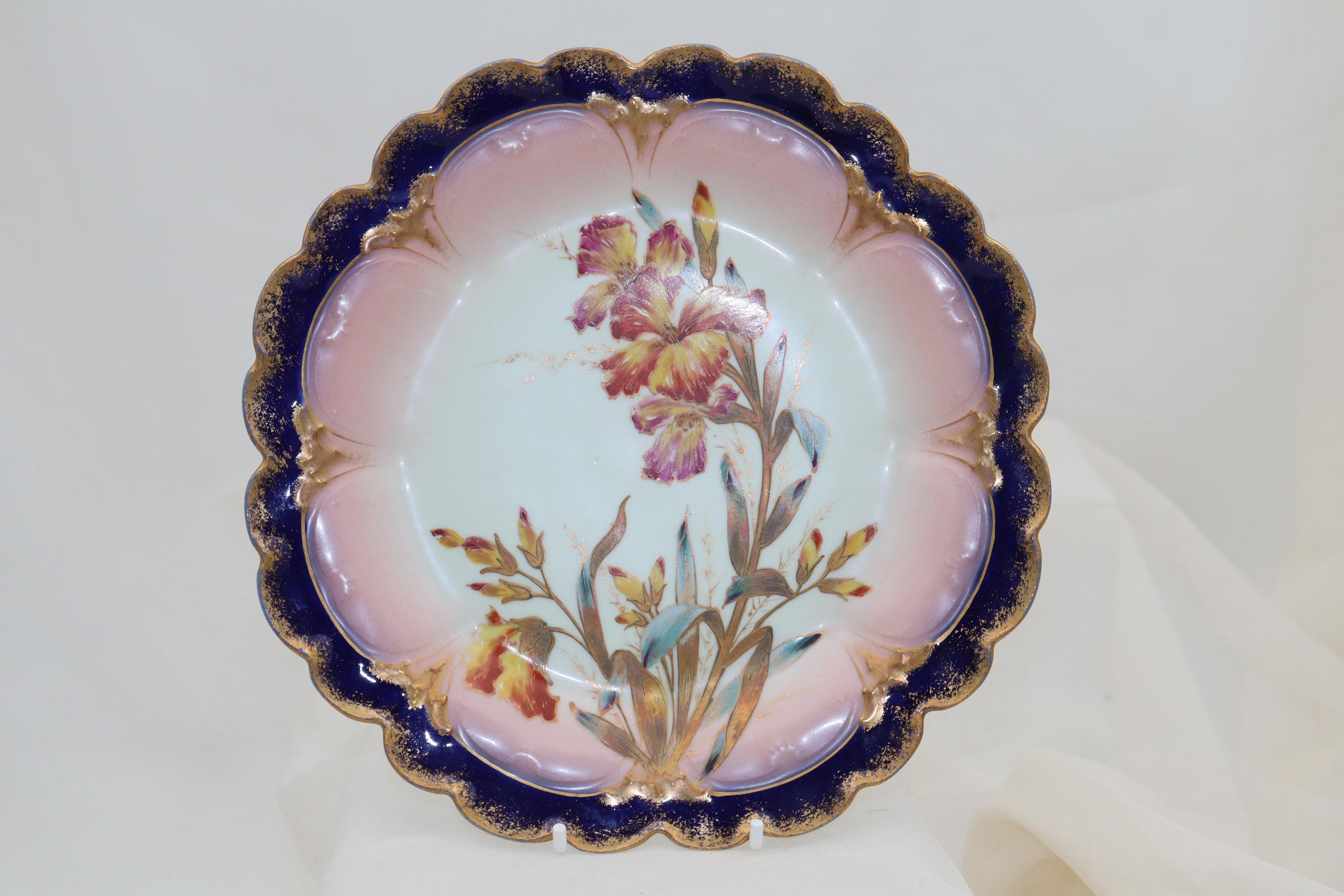 These four hand painted and gilded porcelain dessert plates with a scalloped edge are by the firm of Gerard, Dufraisseix and Abbot, who were known as one of the best producers in the Limoges region of France. The central decoration is of a spray of