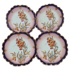 Four hand painted and gilded Limoges dessert plates