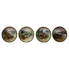 Quatre assiettes de Limoges peintes à la main représentant des faisans, fabriquées par Raphael Weill & Co.