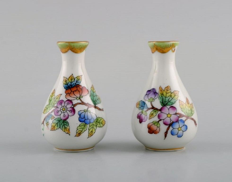 Four Herend porcelain vases with hand-painted flowers and butterflies. 
Mid-20th century.
Largest measures: 8.5 x 4.5 cm.
In excellent condition.
Stamped.