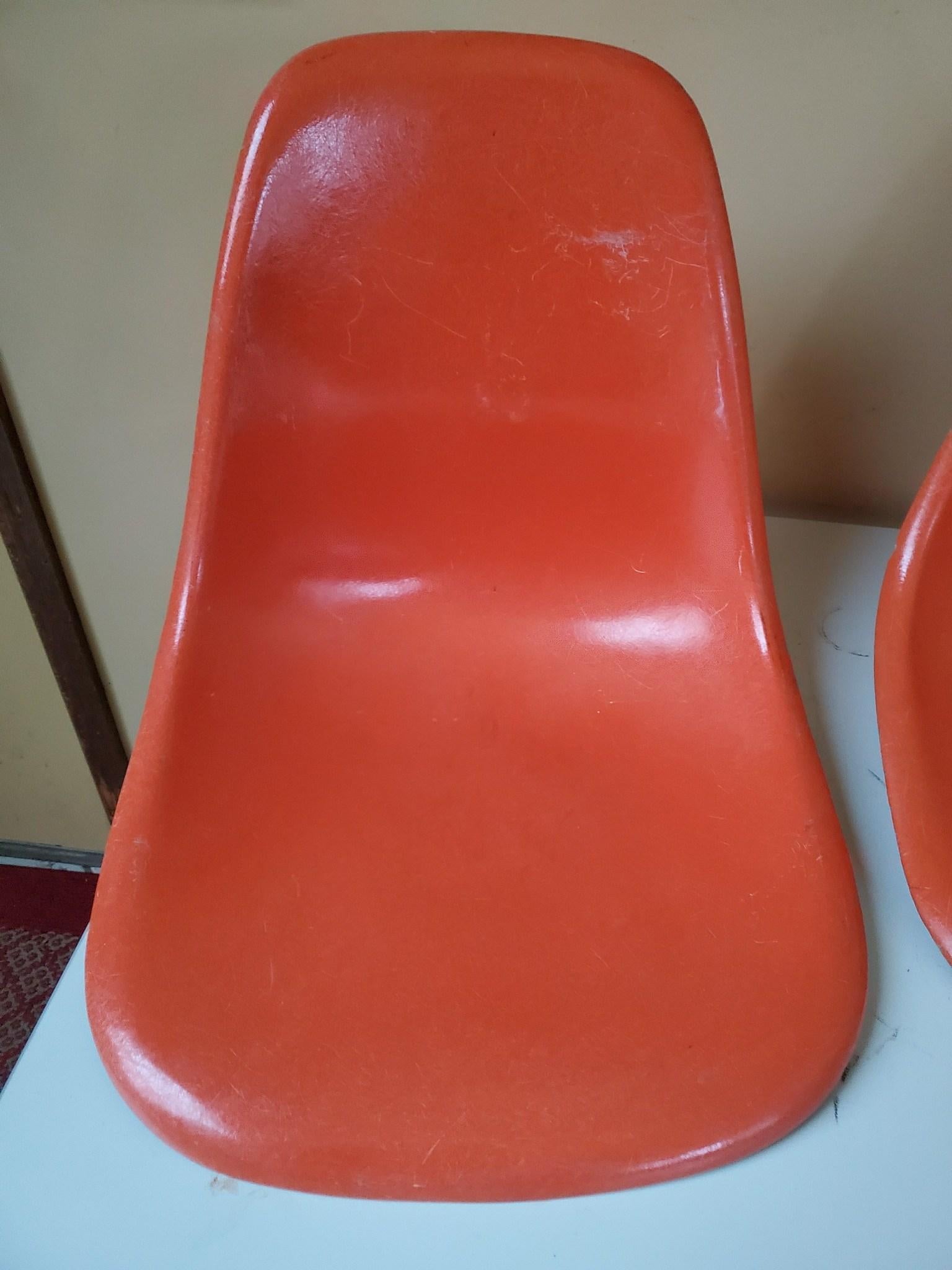 Four Herman Miller Eames dining chairs in red orange. New walnut dowel bases. Shells and bases ship in two boxes. Assembly takes 4-6 mins with a single screwdriver.
  