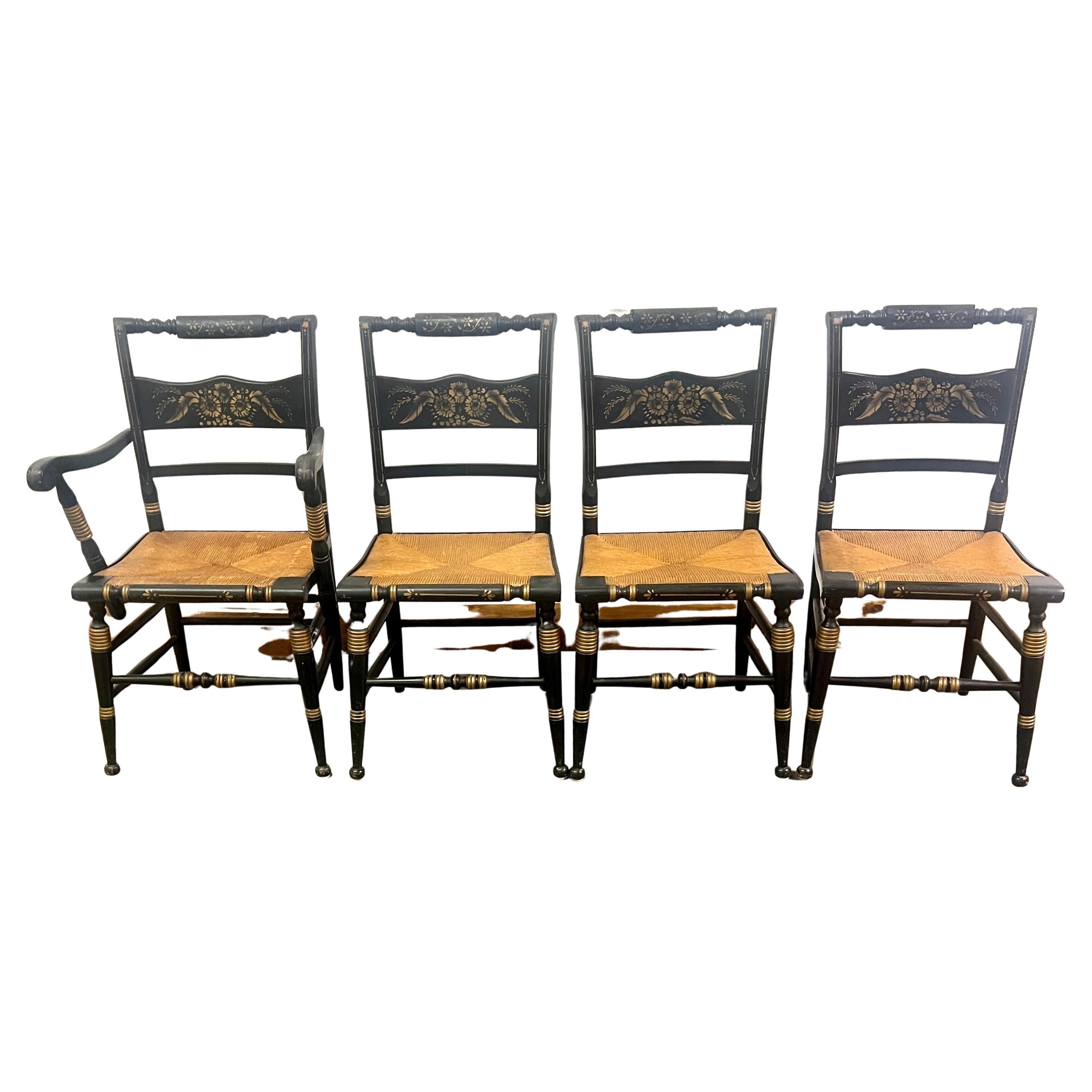 Four beautifully Hand Crafted designed and built wooden Hitchcock chairs with Hand Painted gold accents.  Three without arms and three with arms.  The four are in great condition and also have woven rush seats that are also in great condition.

A