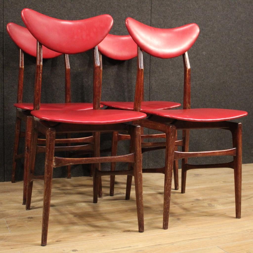 Group of 4 chairs of Italian design from the 1970s. Furniture of particular line and pleasant decor carved in fruitwood and covered in imitation leather. Comfortable chairs with a seat height of 47 cm. One chair has some marks and tears in the
